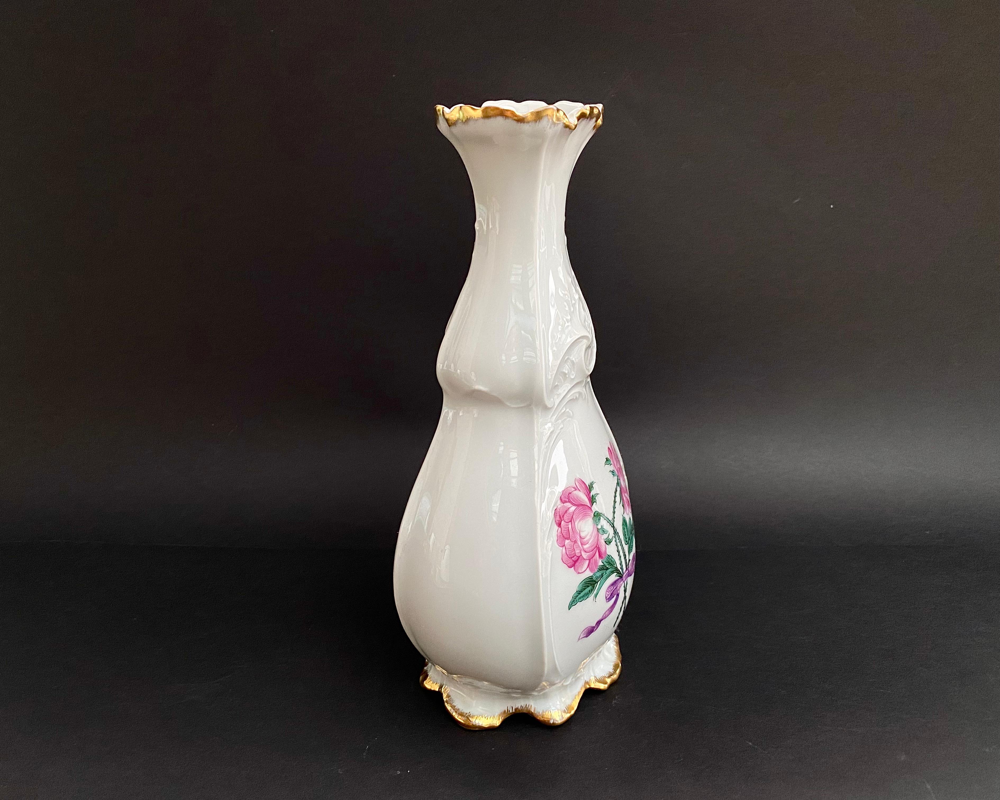 A collectible vintage flower vase made in France by the famous Limoges manufactory, c. 1980s. This exquisite item is handcrafted from high-quality porcelain.

Delicate white and pink colors prevail. The main color of the vase is pure white, which
