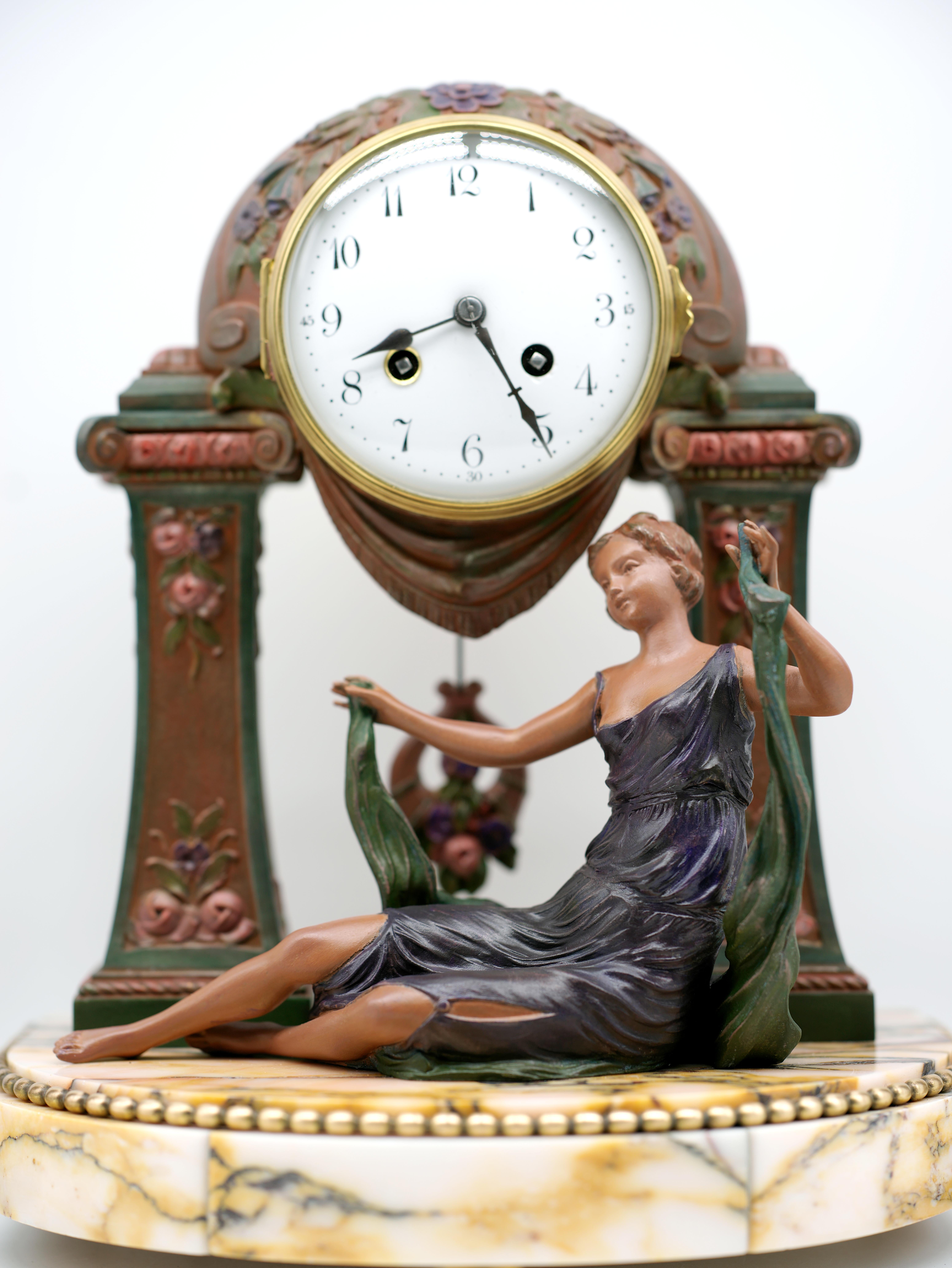 This French Art Deco mantel clock set, designed by Georges Limousin in the 1920s, features a striking combination of materials including spelter, marble, bronze, brass, and glass. Influenced by the Süe & Mare style, the set is marked by its superb