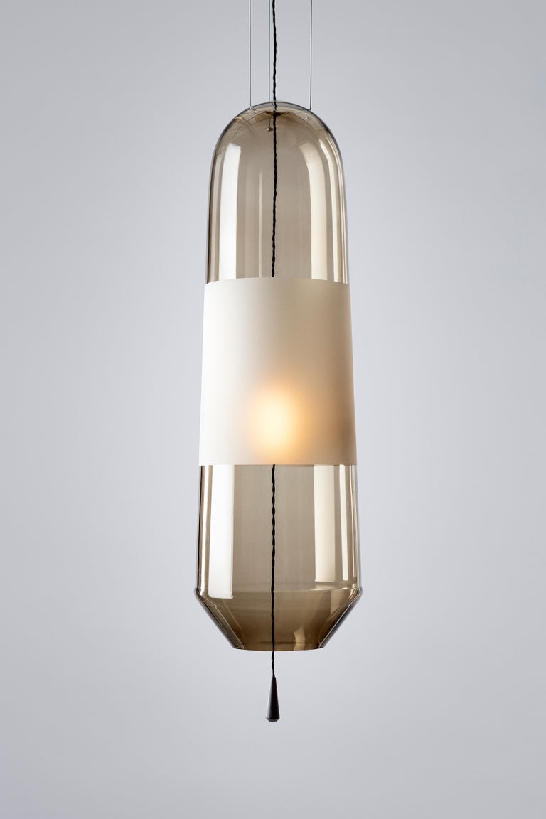 To order the Full-swing version please check our storefront.

Our limpid light size L in shade “Smoke” is a pendant light, decorative light, made in Europe.
The Limpid Lights collection, a series of lighting objects that incorporate movement as a