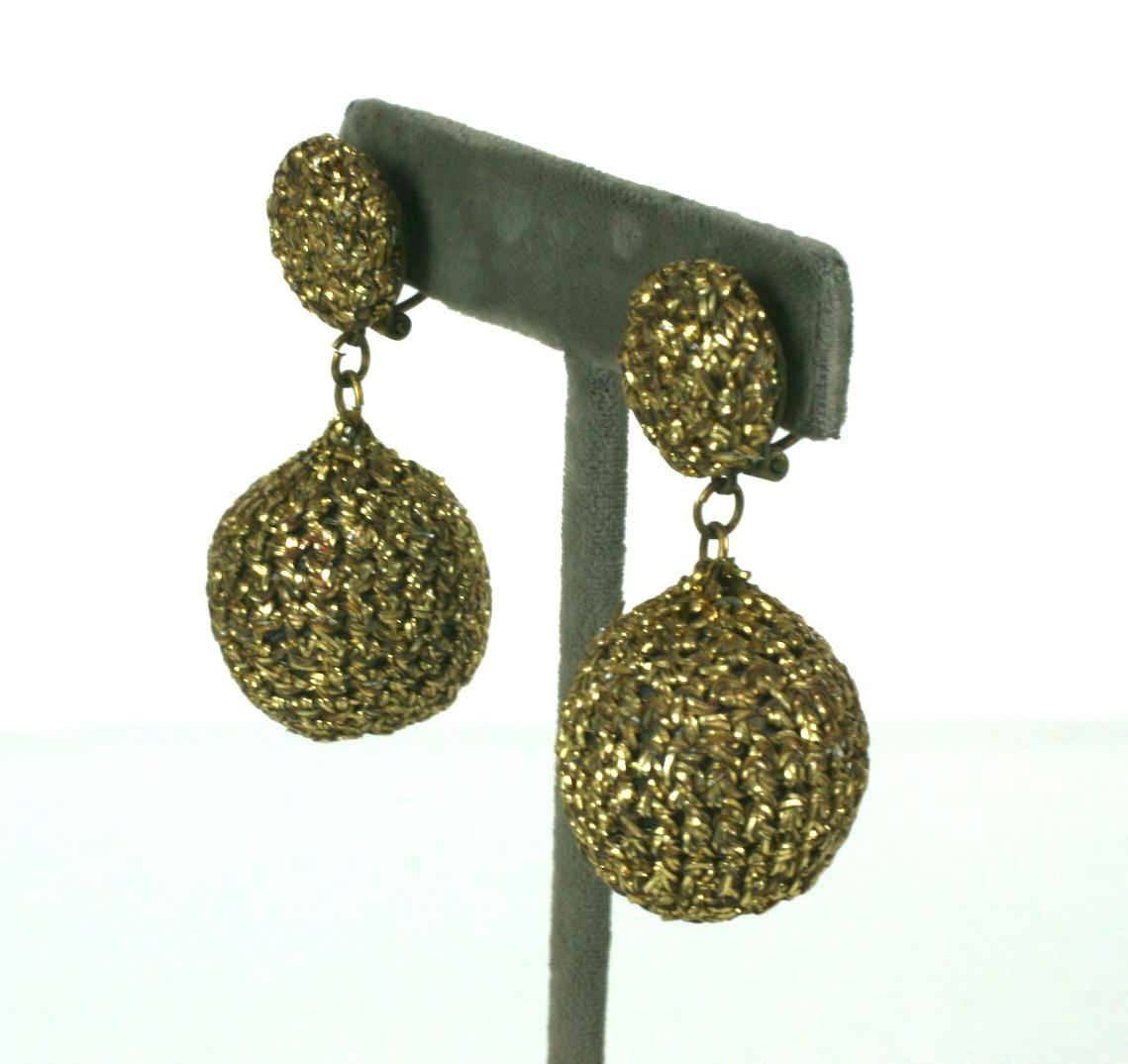 Lina Baretti unusual knitted gold metallic cord drop earclips. The knitted gold cord made to imitate pierced metal filigrees.  Composed of a round gold hand knit cabochon, suspending a large gold hand knitted round drop.
Lina Baretti created
