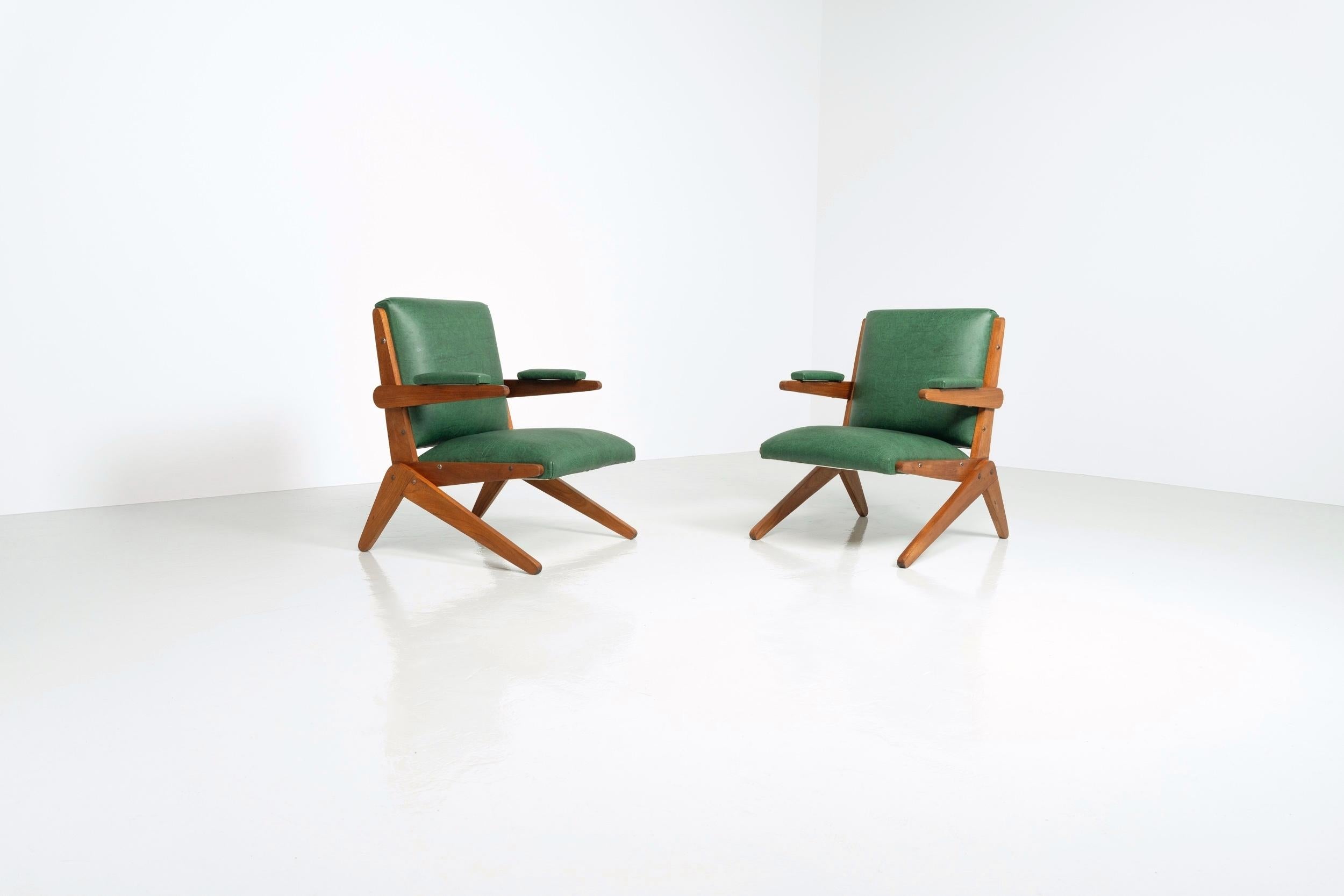 Super rare and beautiful, fully original 'scissors' lounge chairs designed by Lina Bo Bardi and manufactured by Studio D'Arte Palma, Brazil 1948. These chairs have stunning solid teak wooden structures and original old green leatherette upholstery.