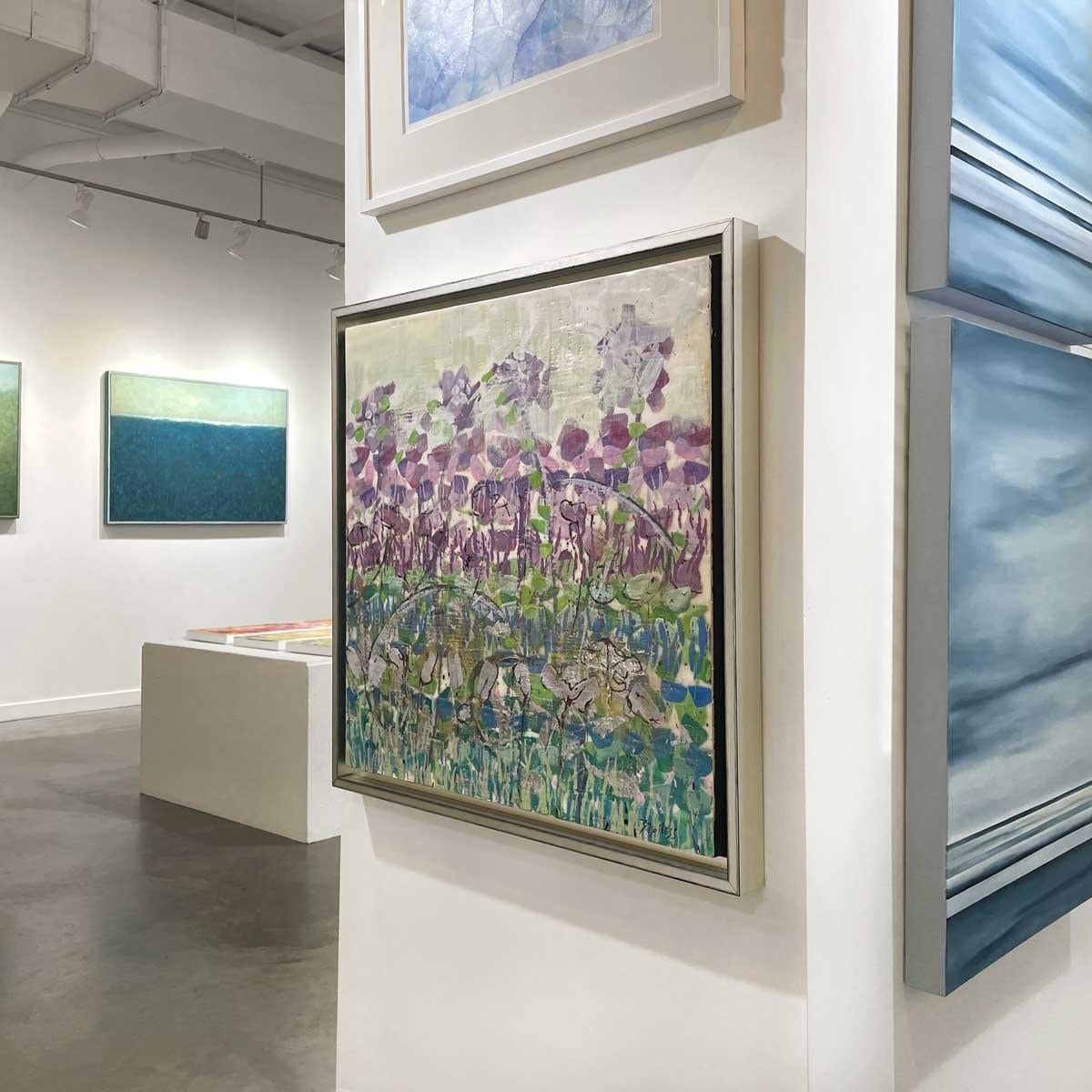 This abstract floral encaustic painting by artist Linda Bigness features a predominantly green and violet palette. Organic shapes and dabs of brush strokes are arranged in loose horizontal rows of purple, green, and blue, all layered in varying