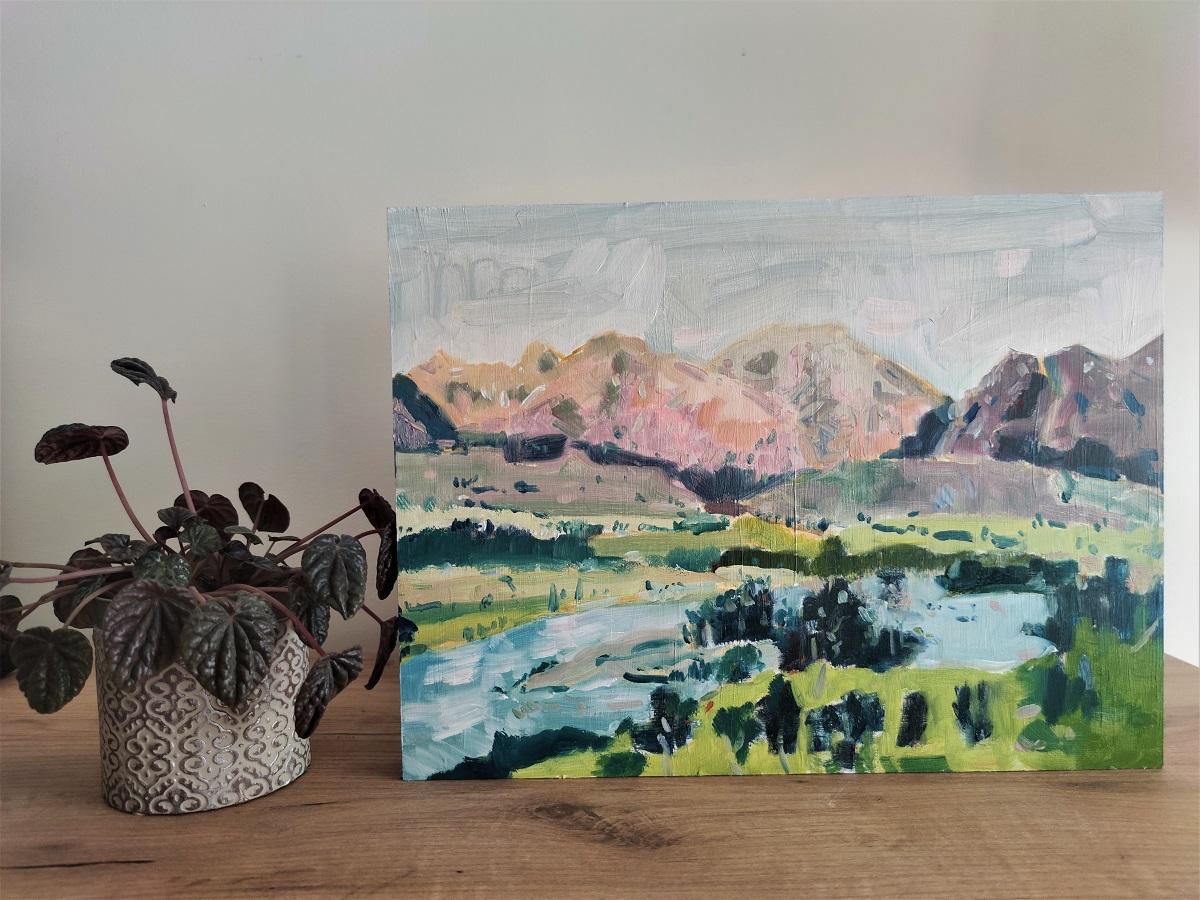 It's an oil on wood panel with a built-in hook on the back, three centimeters thick. The panel can also be placed on a table. 
It represents the artist's desire to explore the great wilderness, and is inspired by Yellowstone National Park. 
The