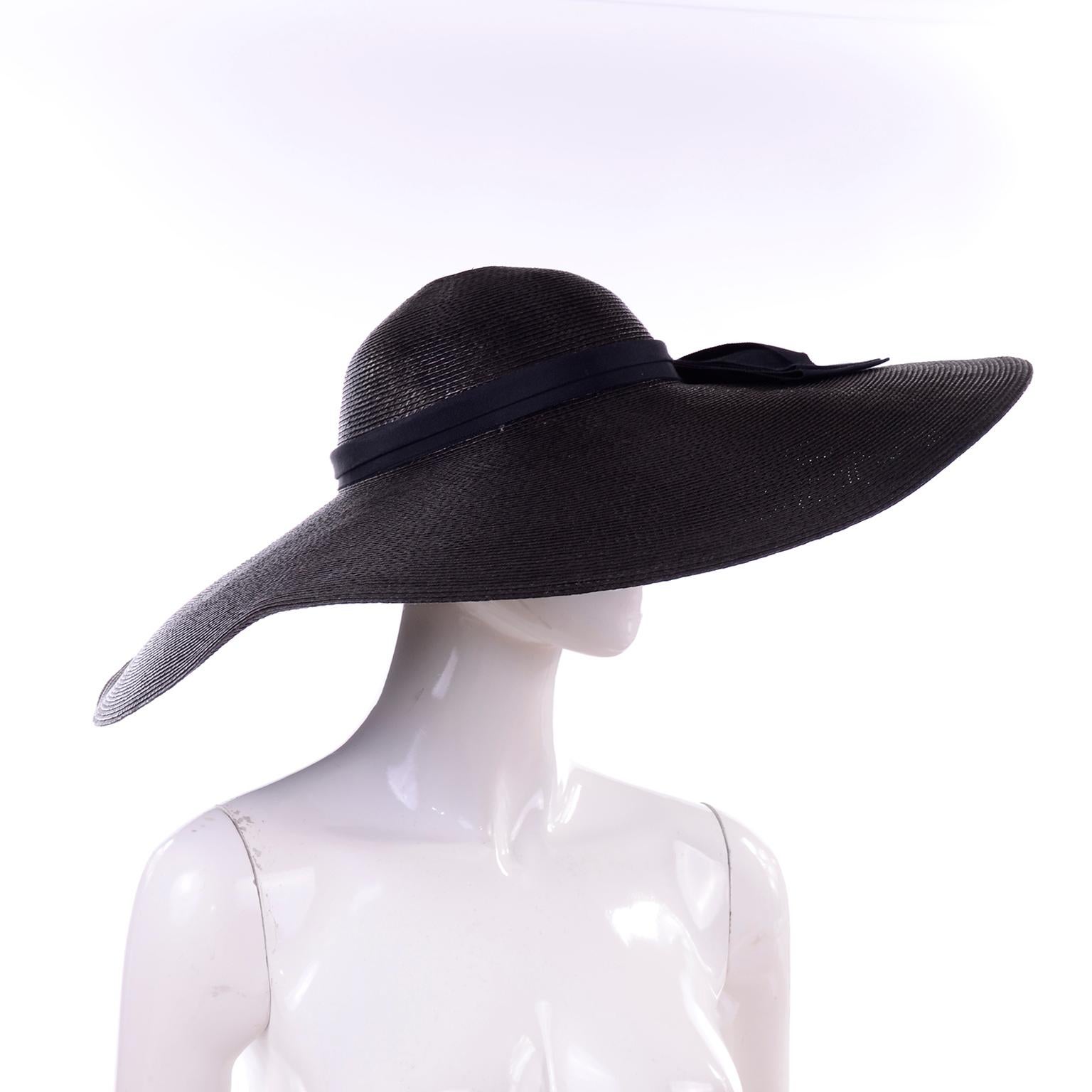 This is a fabulous Linda Eastwood extra wide brim black straw sun hat with a large black bow on the back. This has the LInda Eastwood label and another one that reads; 707. The perfect summer hat with so much style!  Head Circumference: 22