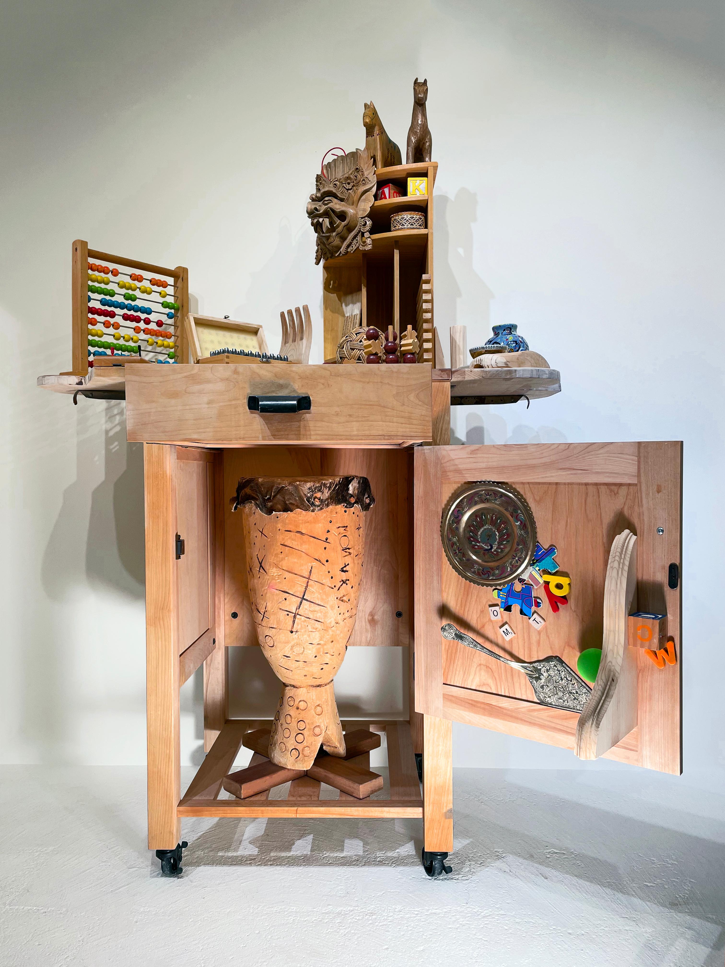 Linda Stein, Essentials for Moving 1133- Sculpture en bois mixte contemporaine