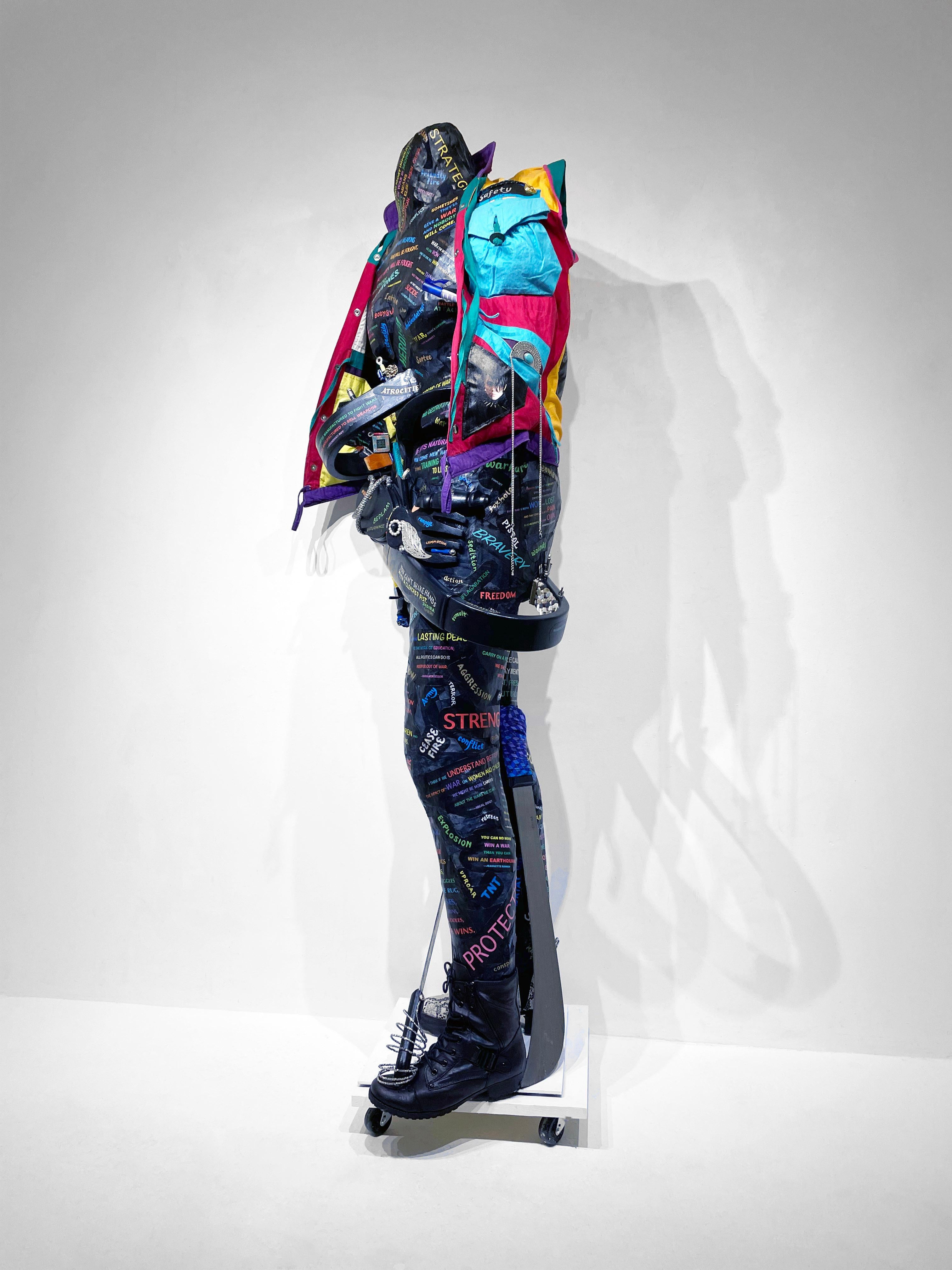 Linda Stein, Warrior Waging Peace: Addressing War 1277 - Feminist Figurative Mixed Media Black and Colorful Contemporary Sculpture 

Free-standing contemporary sculpture with vest including images of comics Wonder Woman. Written over body are quotes