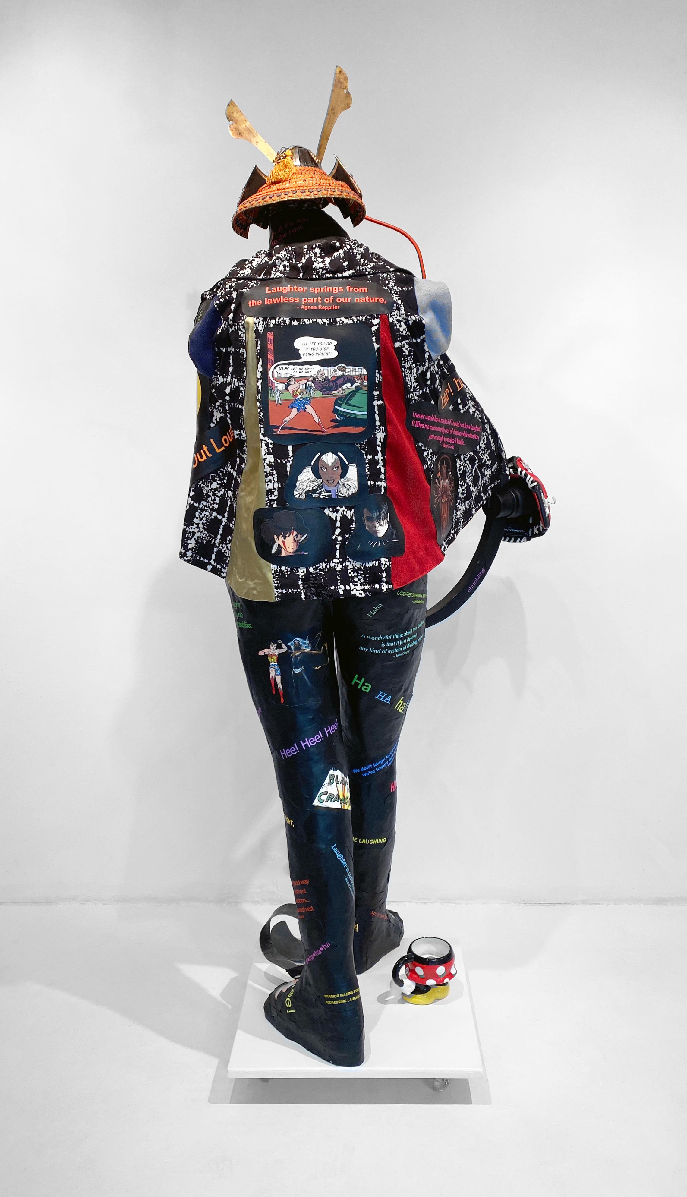 Linda Stein, Le guerrier au service de la paix : Aborder le rire 1280  - Sculpture contemporaine féministe figurative en techniques mixtes, noire et colorée 

Sculpture contemporaine autoportante dont l'Icone comprend des images de bandes dessinées