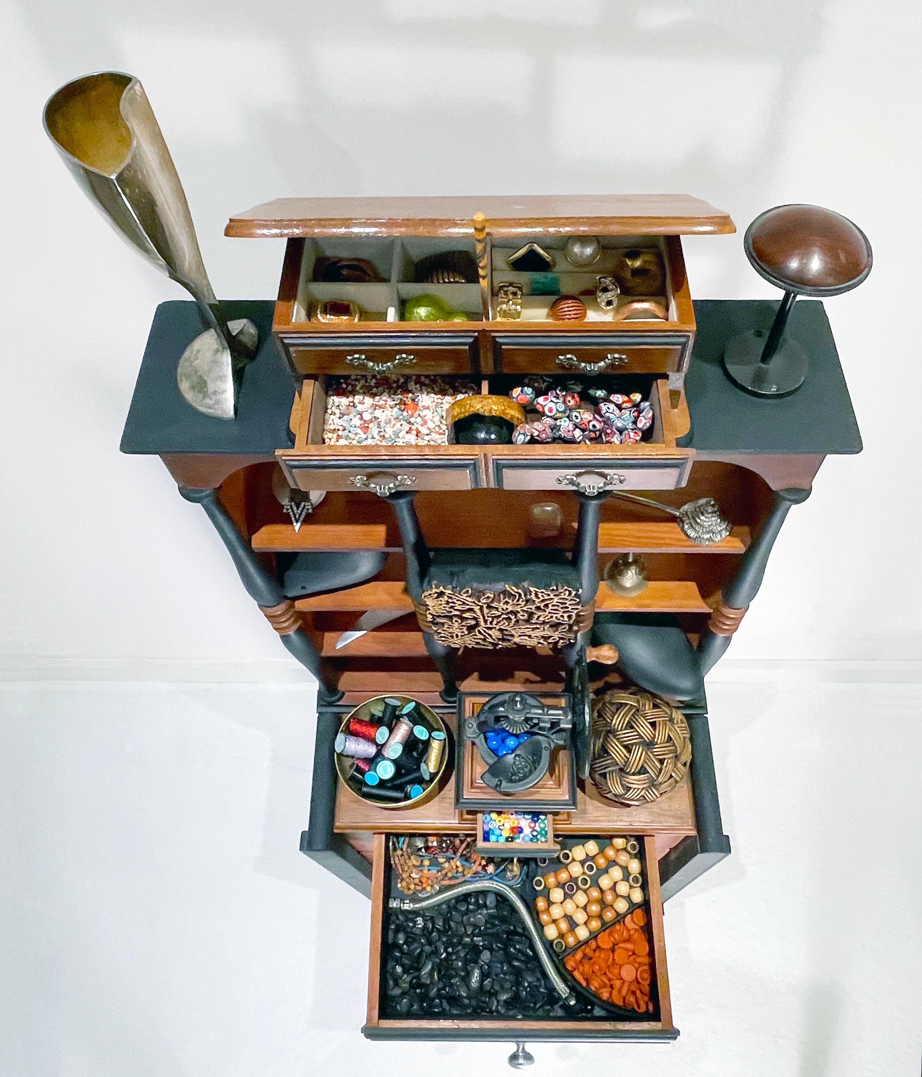 This work from Linda Stein's Displacement From Home series draws from the tradition of wunderkammer/cabinets of curiosities to highlight the global displacement and traumatic memory of migrants and refugees around the world. 

Works from this series