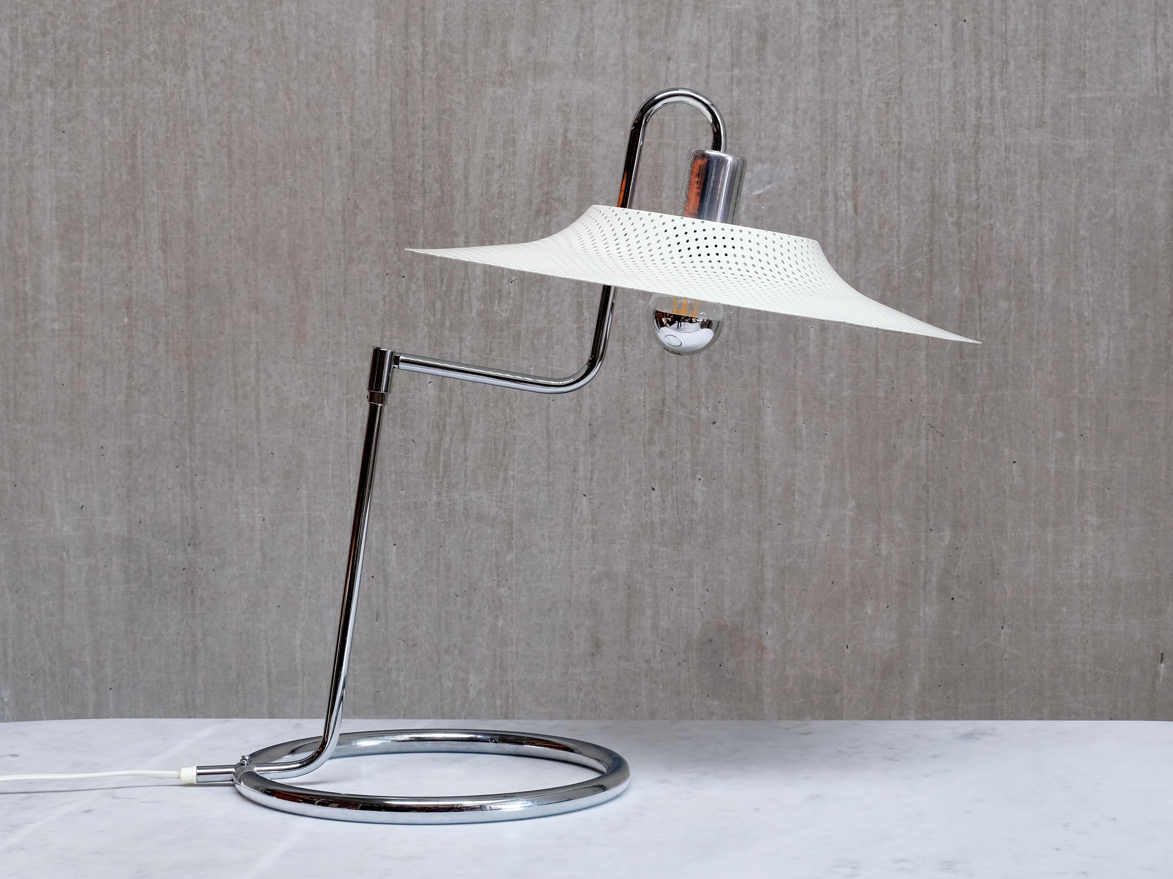 This rare table or desk lamp was designed by Börje Lindau and Bo Lindekrantz and produced by Zero Belysning, Sweden, in the 1970s. The piece retains its original manufacturer’s sticker on the base.

The lamp is distinguished by its ring-shaped base