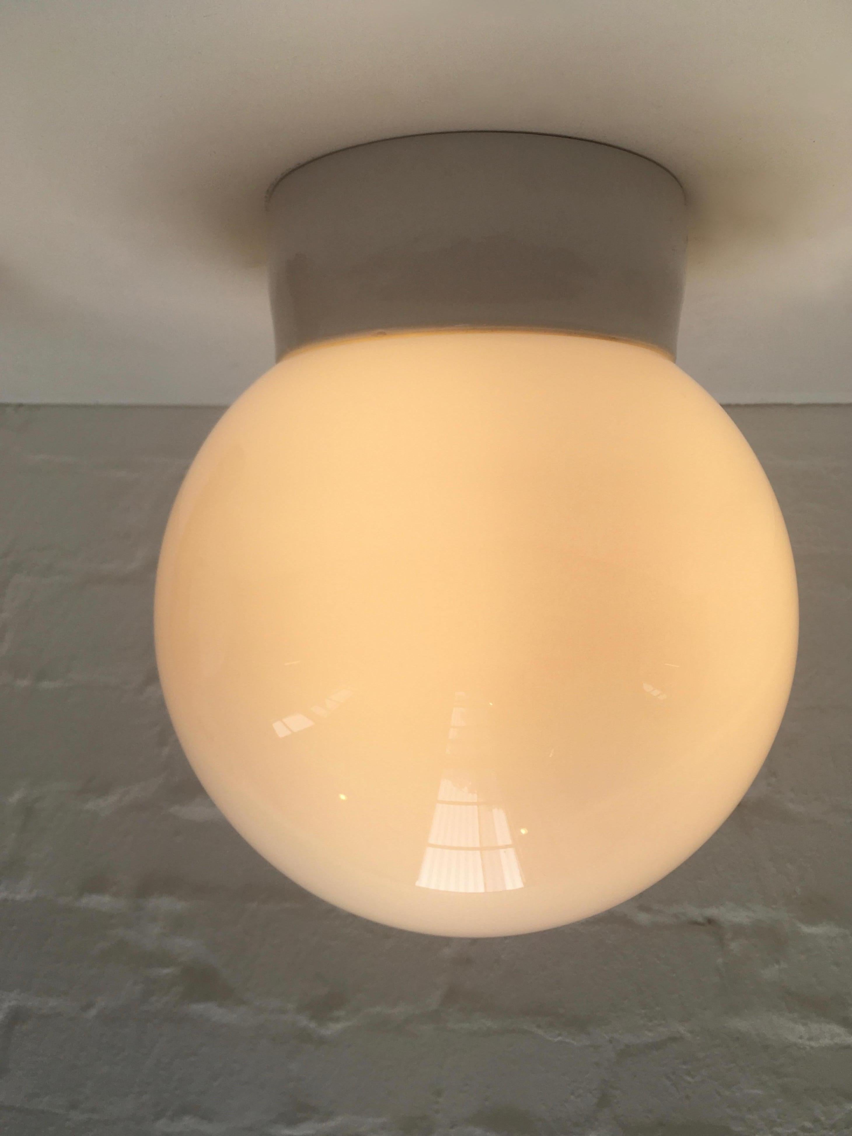 Four original large Lindner Leuchten Bauhaus ceiling or wall lights. This is a very unusual size to find in any quantity, being larger than the standard Lindner globe light. See images for scale set against a standard wine bottle. 

This simple,