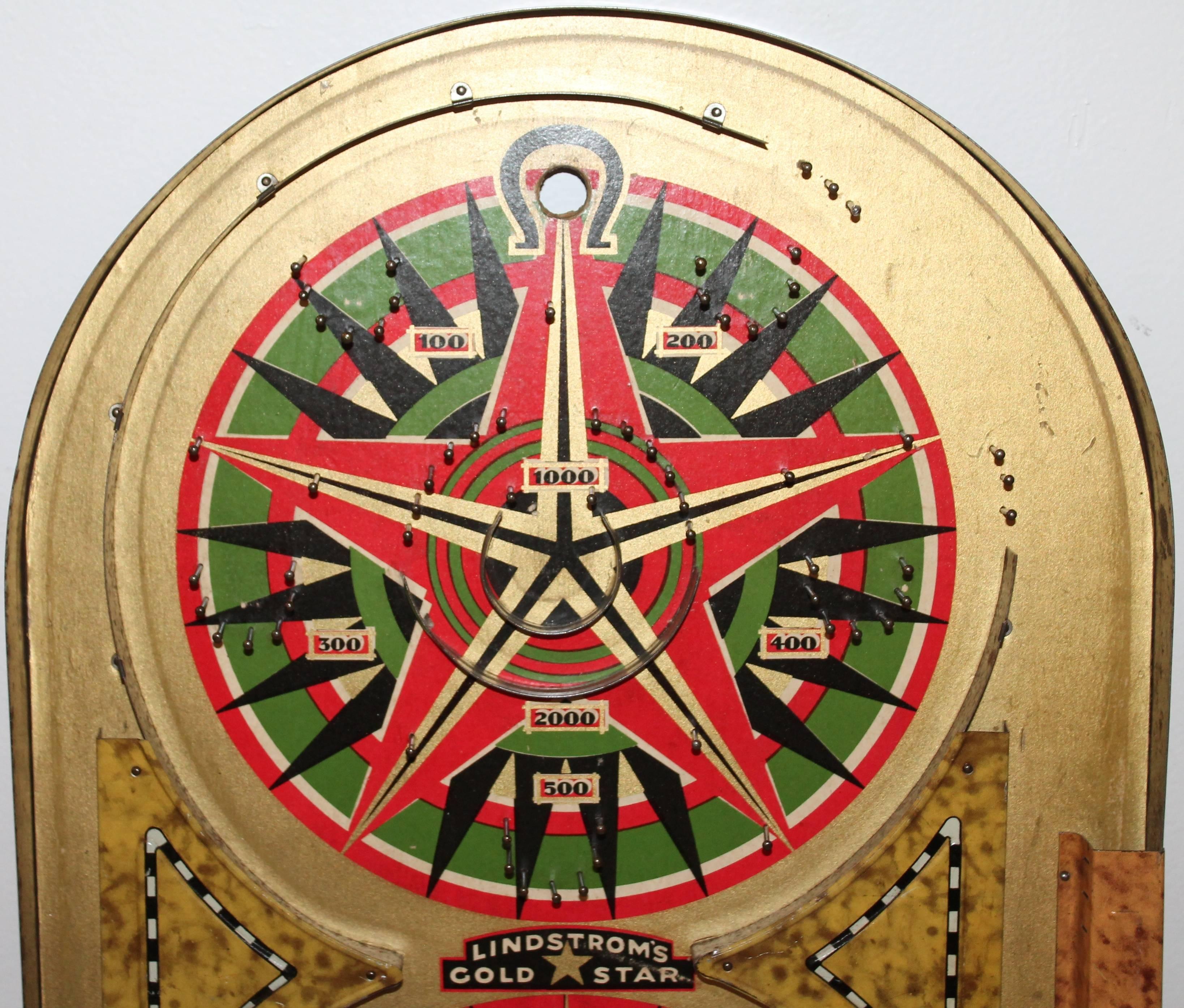 This mariner compass marble game board is in amazing condition and is all completely original. It has the original label on the reverse and was manufactured in Bridgeport, Conn. and dated 1934. Great hanging on a wall.