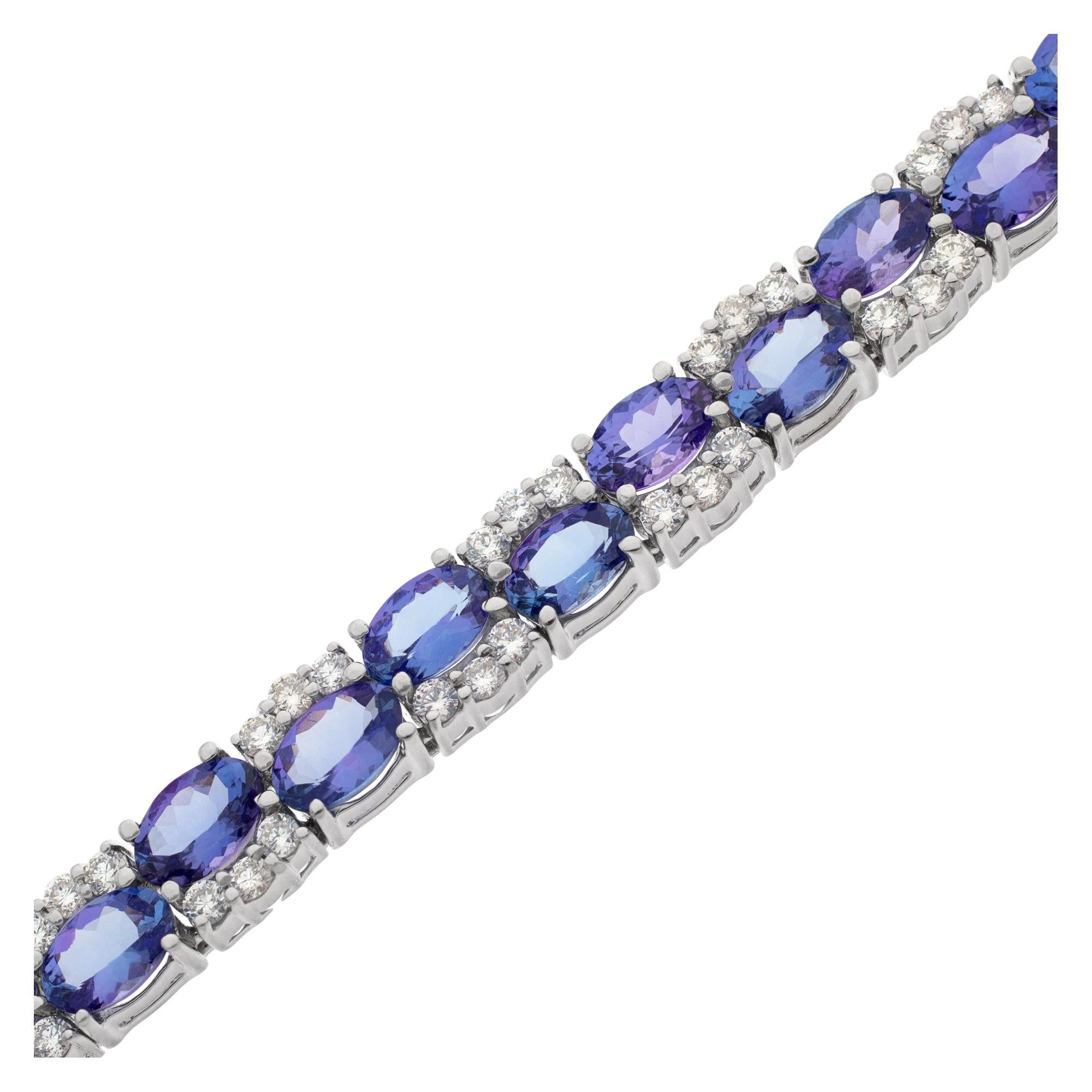 Diamond and tanzanite line bracelet in 14k white gold with 2.45 carats in round diamonds and 14.75 carats in oval tanzanites. 7mm in width. 7 inch length.