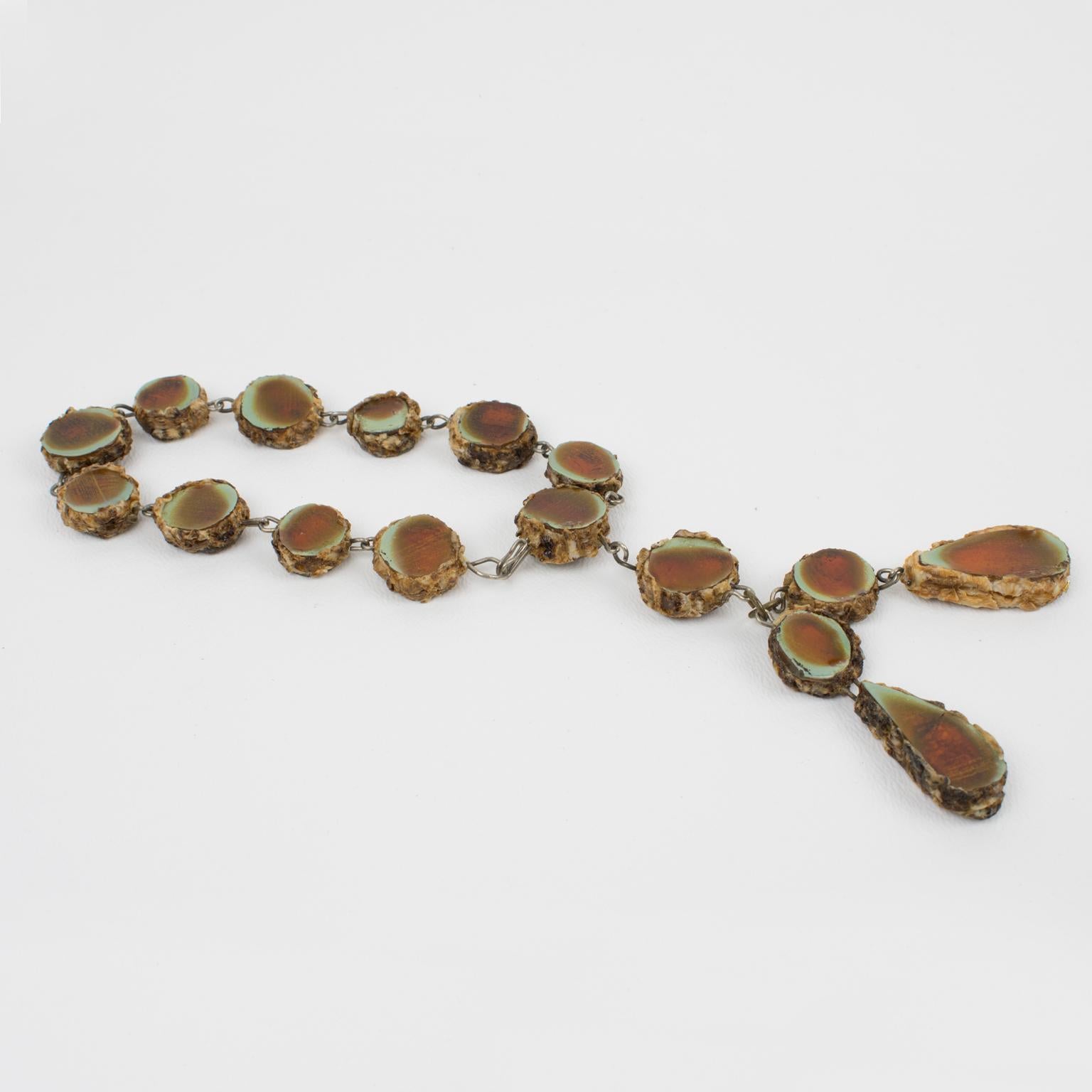 Stunning 1960s Talosel resin bracelet by Line Vautrin, Paris. Tan-brown colored resin or Talosel link shape with encrusted tinted glass. Glass color is a lovely honey brown tone with sea-foam green edges. Unusual dangling charm on the