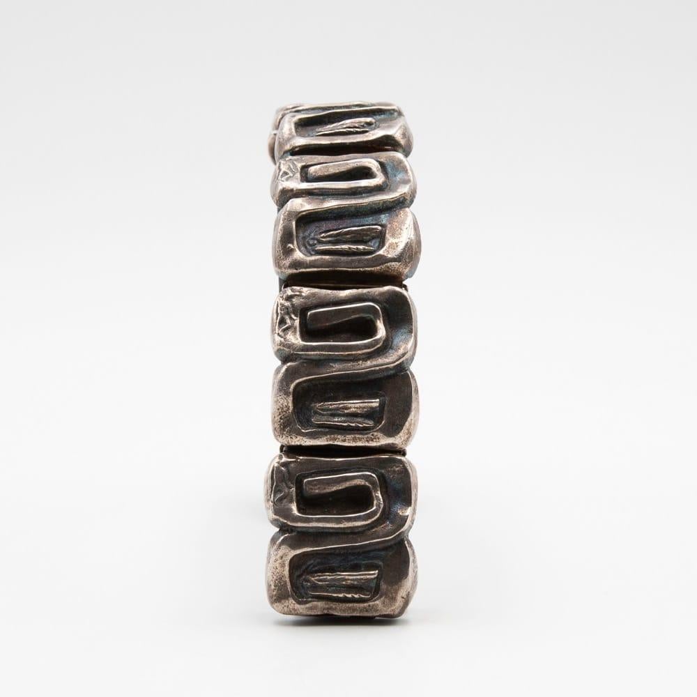 Icare, an articulated large bracelet, band designed and produced by Line Vautrin, circa 1955-1960.
The bracelet consists of 6 labyrinth-shaped links representing one side Icare lying and the other Icare flying
Very good condition and has not been