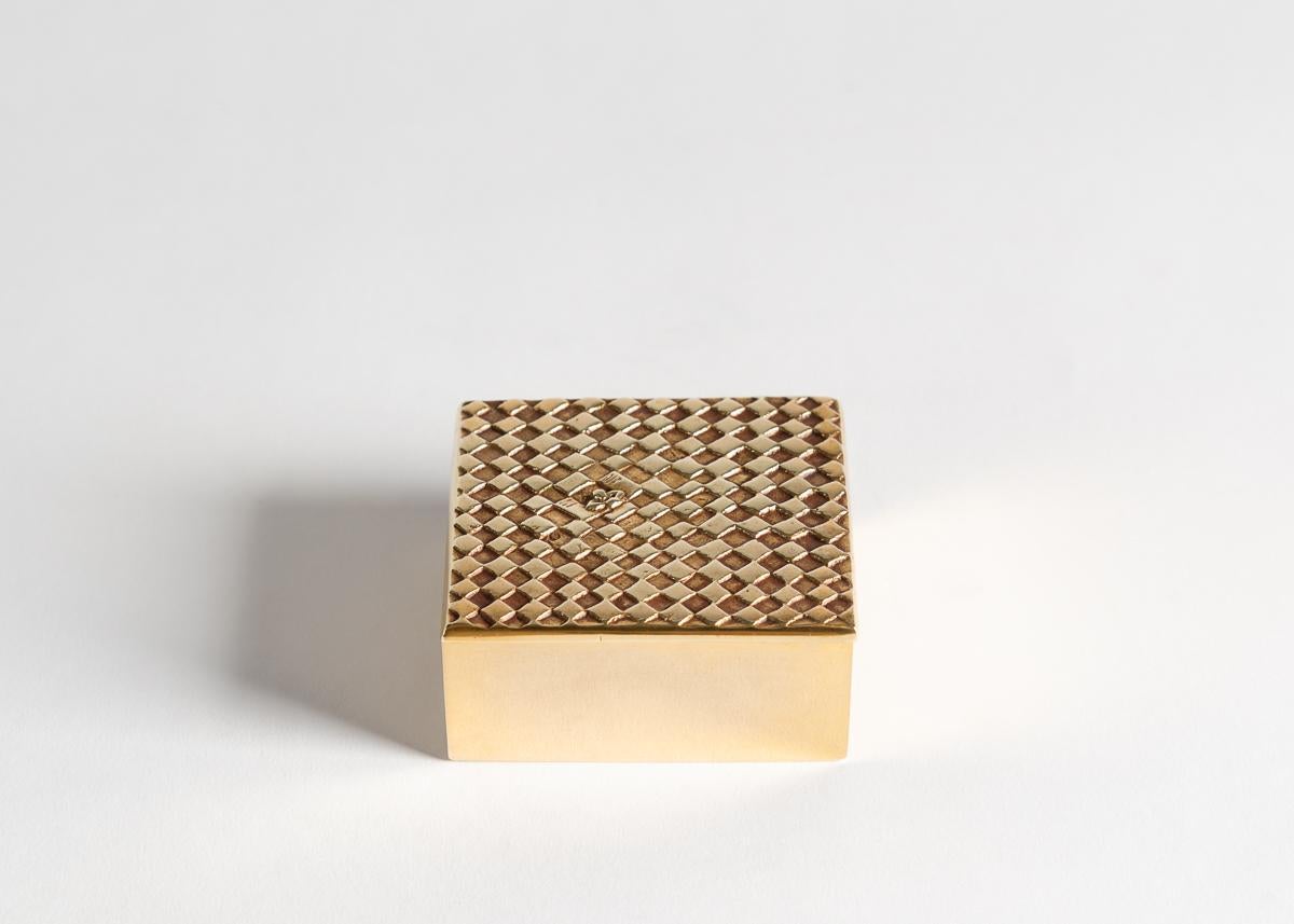 The reverse side of this exquisite bronze doré box is decorated with hearts. Its top is covered in a checker board abstraction from which a stranger pokes out his lonely head.