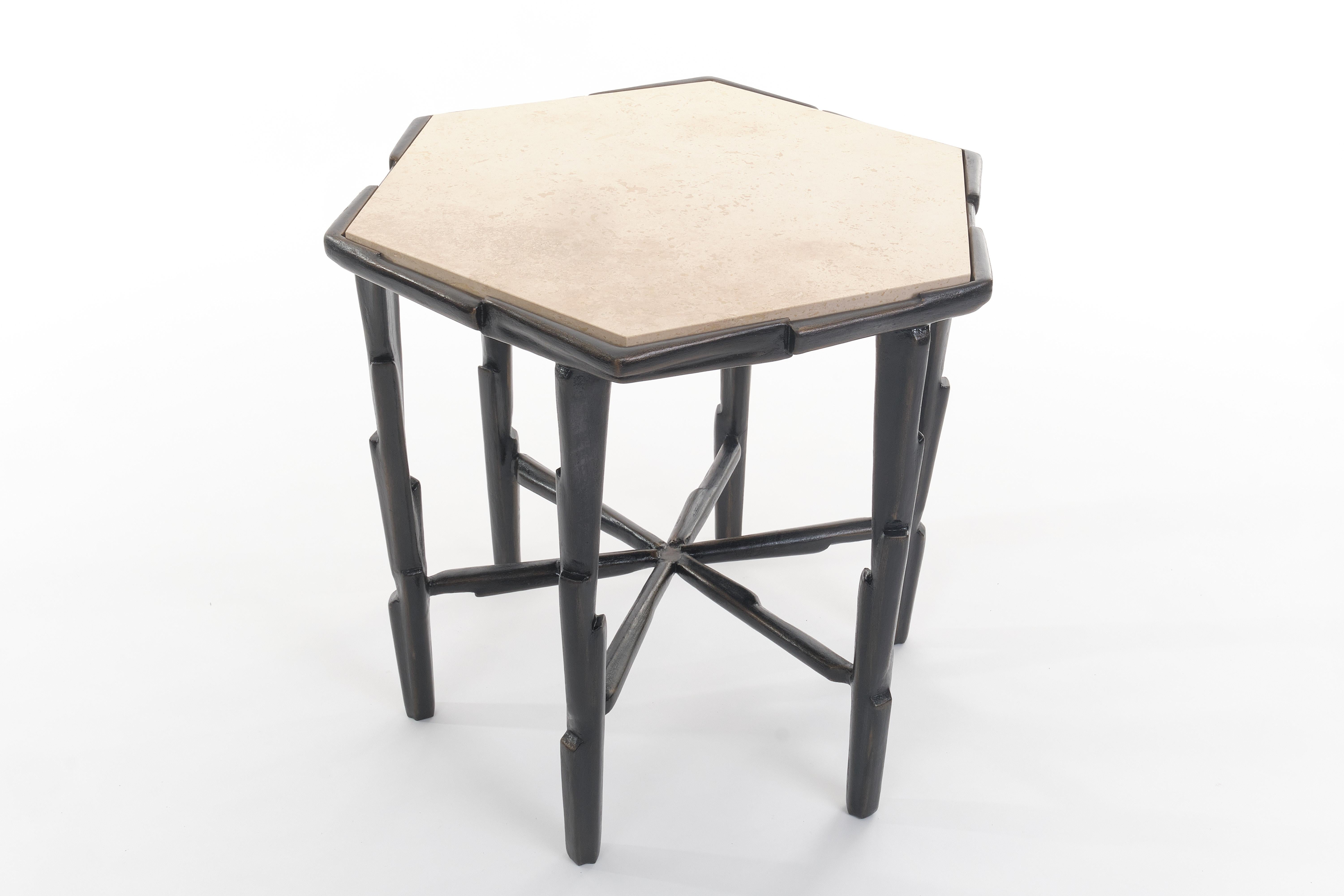 The LINEA side table has a strong and dynamic silhouette. Geometric composition based on the figure of the triangle. Base of plaster over iron. The piece of furniture is crowned by a travertine top. The stone is set in a hand sculpted frame. The
