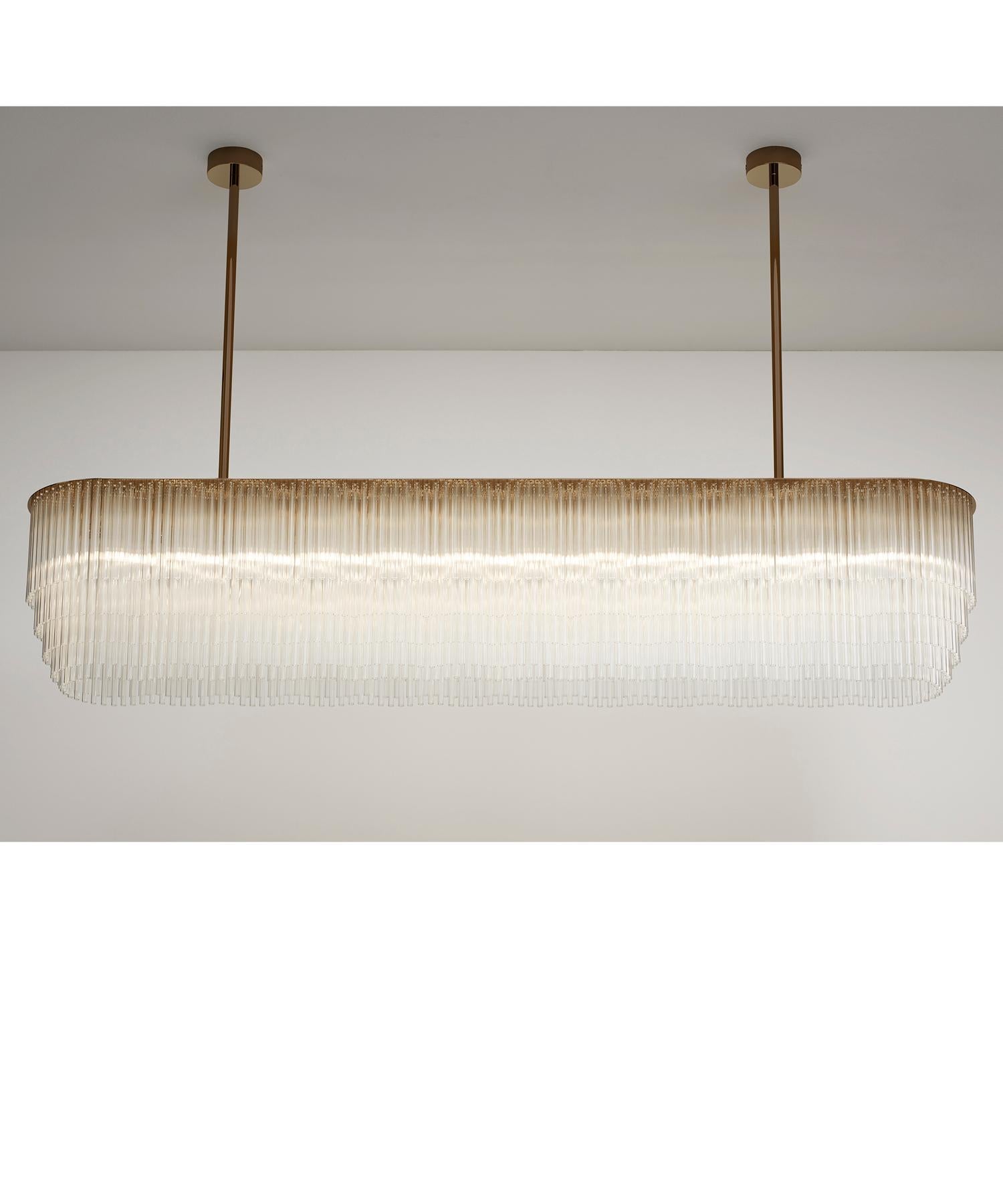 Der Linear Chandelier mit seinem markanten Profil aus gestuftem Glas ist die perfekte Lösung für Innenräume, die eine moderne und funktionelle Lichtquelle erfordern. Sie lässt sich wunderbar über Esstischen aufhängen oder als dekorativer Akzent in