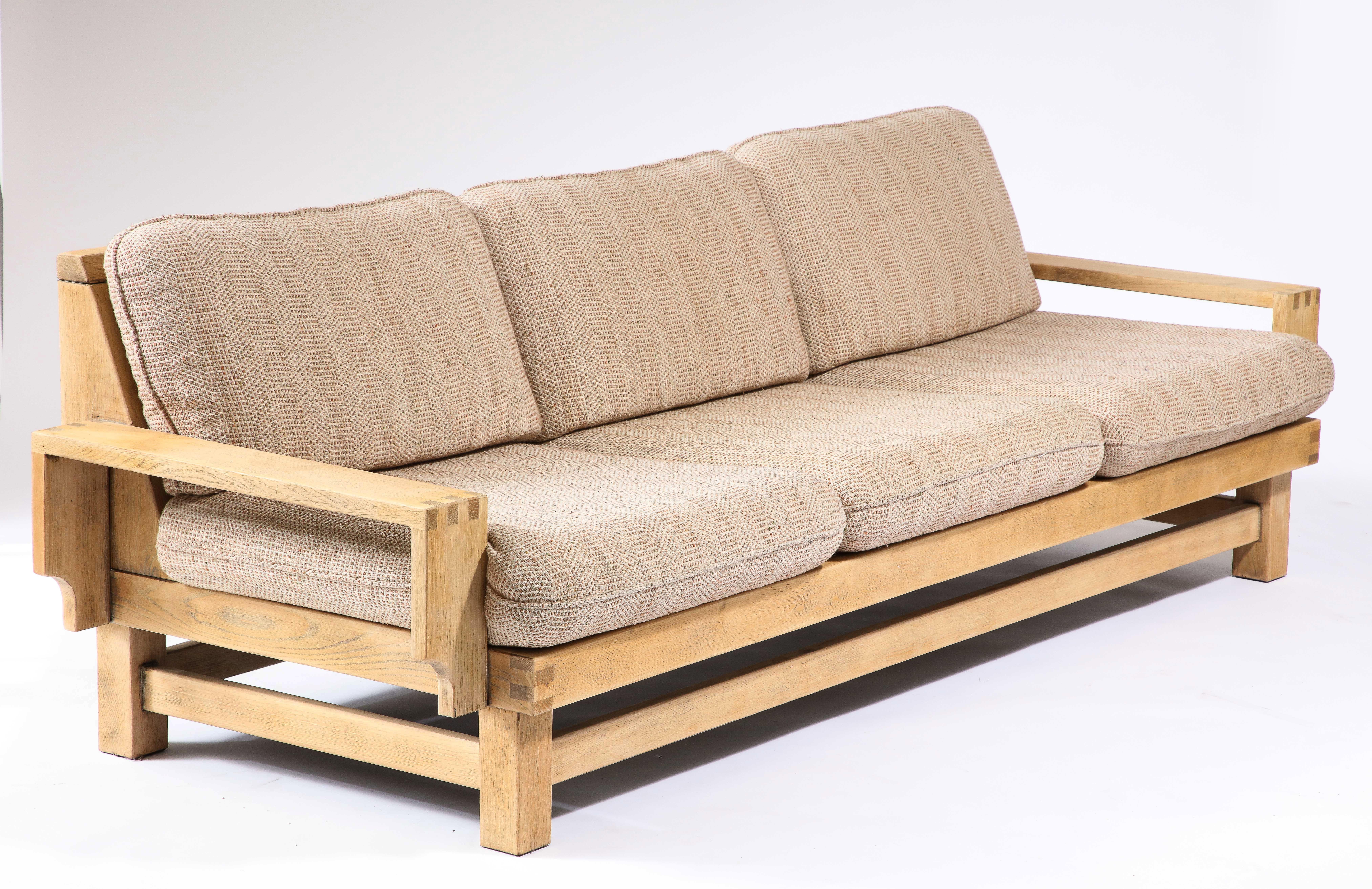 Handmade oak sofa with exposed finger joints and newly made cushions, with linen upholstery.

The back features a fabric panel, making this an ideal piece to float in a living room.