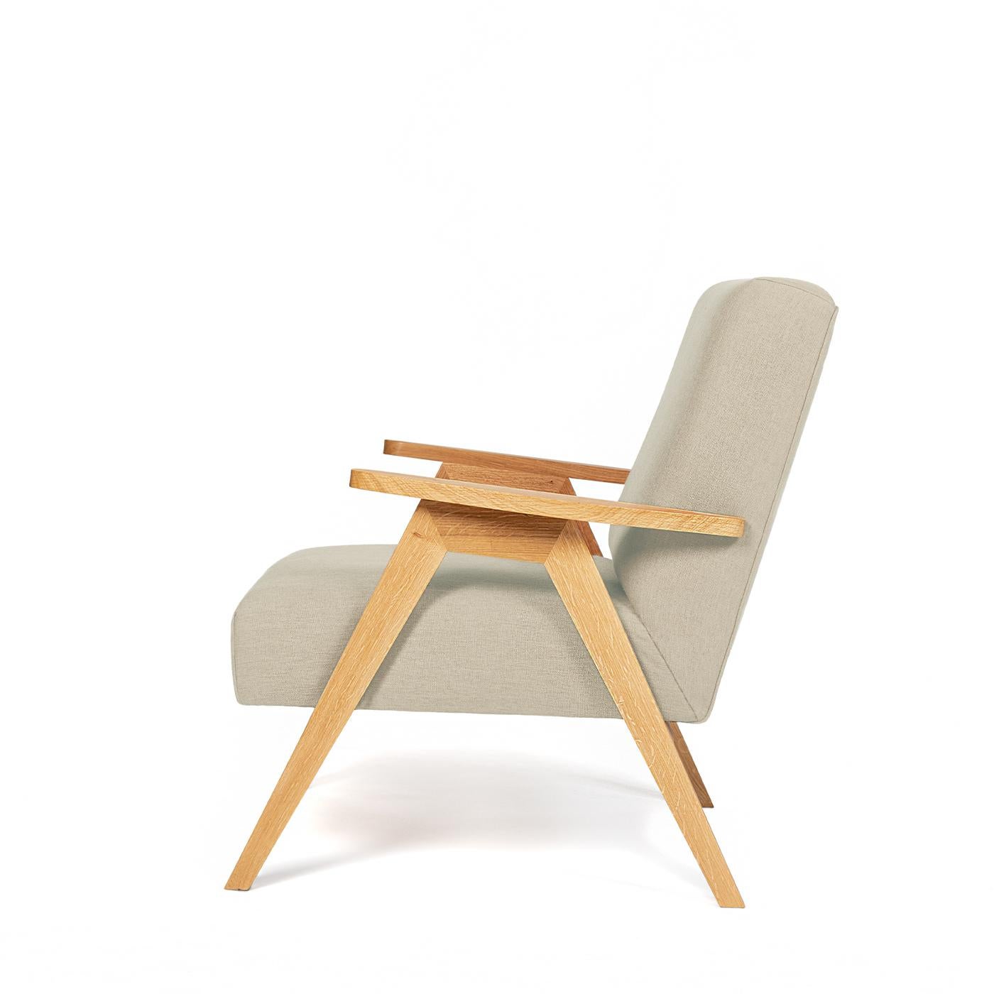 Sink into this comfy, modern armchair with a solid oak structure and an oil-based varnish finish for a clean, simple look. The chair's seat and back structure are in plywood and have foam padding inside for a soft feeling. The non-removable seat