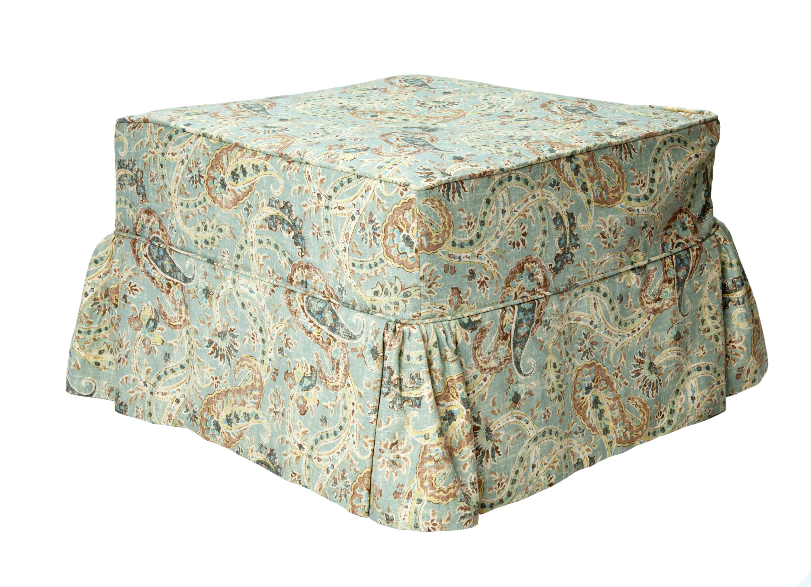 Beautiful square ottoman upholstered in simple beige fabric. On wheel for easy moving.
The fitted slipcover has a skirt with gathered corners. Made in lined paisley linen.
Perfect size to tuck away or use as a coffee table and/or seating.