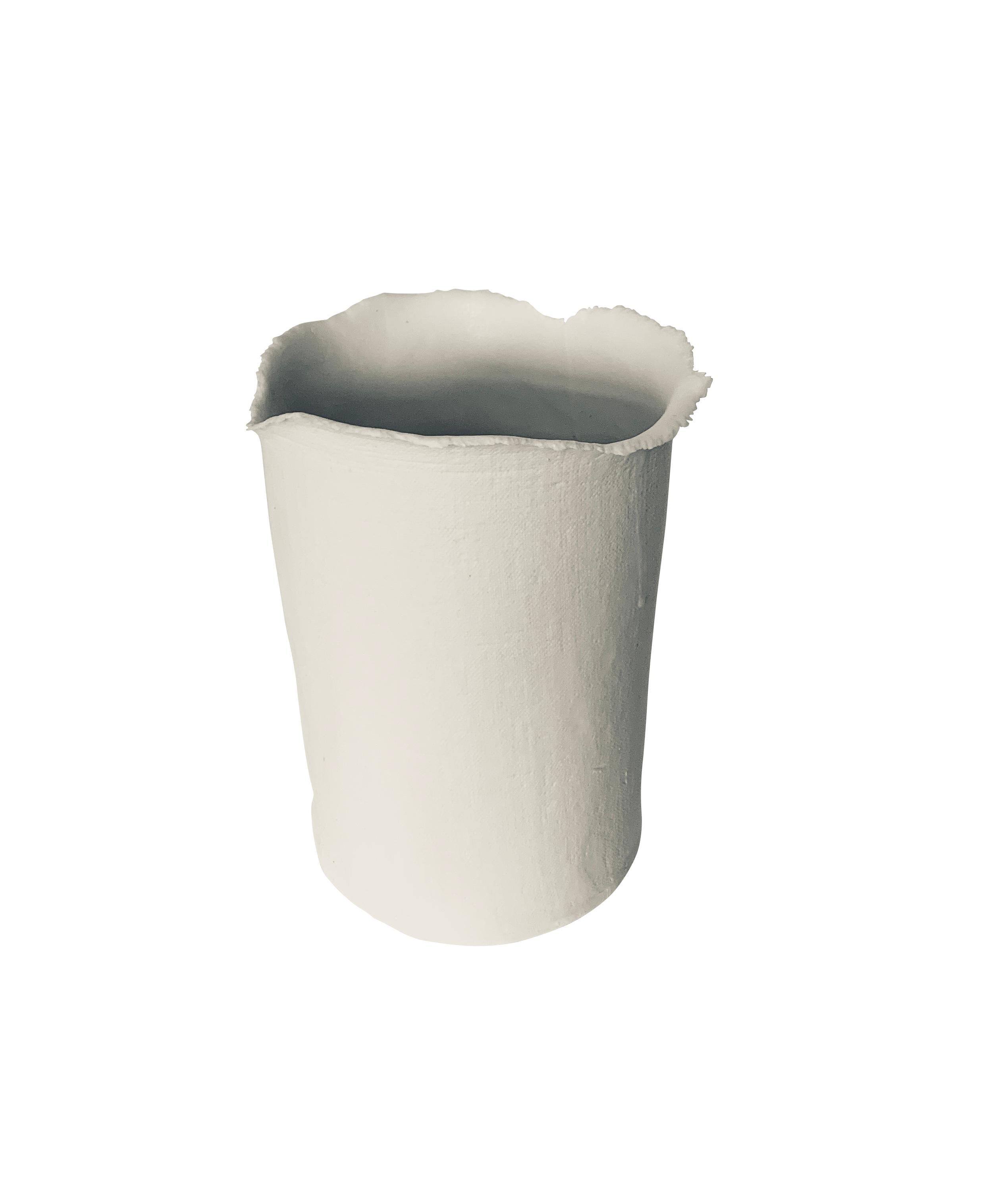 Contemporary French handmade white fine ceramic cylinder shaped vase is a one of a kind piece.
The vase is fine ceramic with a textured surface that looks like linen.
The mouth of the vase has an unfinished rough edge detail.
A collection of five