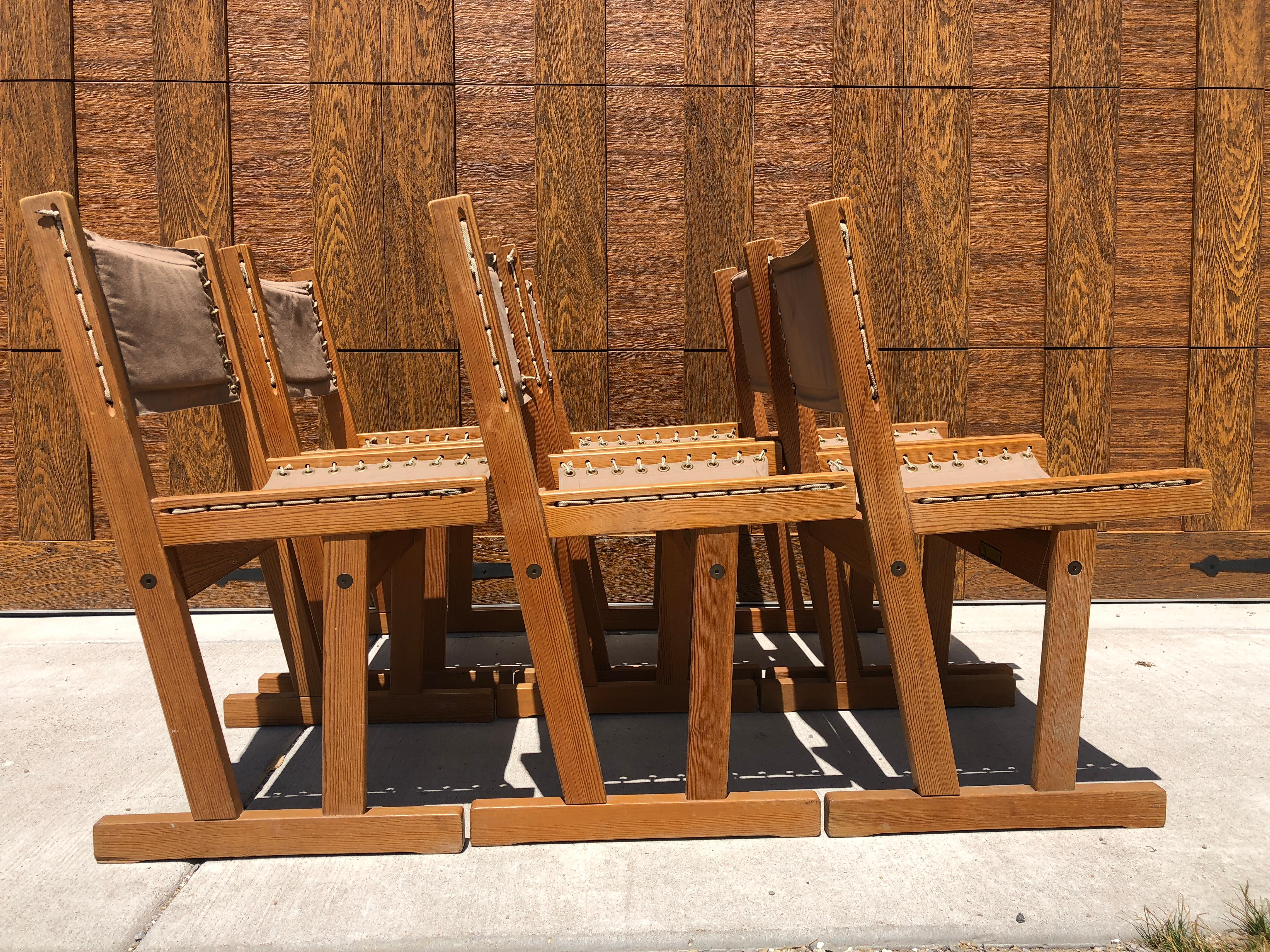 Elegant and classic set of dining chairs by Svein Bjjorneng circa 1965 Scandinavia The linen is in good condition on 5 of the 6 chairs. The 6th chair has a tear near the rivet and is in that condition as of now unless otherwise changed.