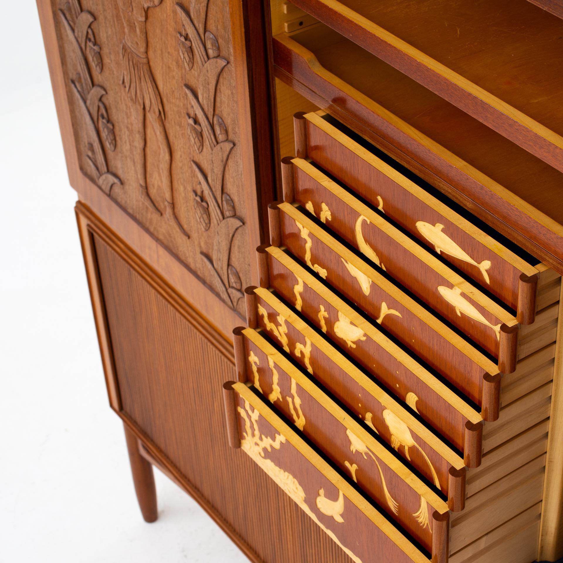 Unique linen-press in Honduras-mahogany with tambour and decorative carvings, from 1950. Maker Arnold Petersen.