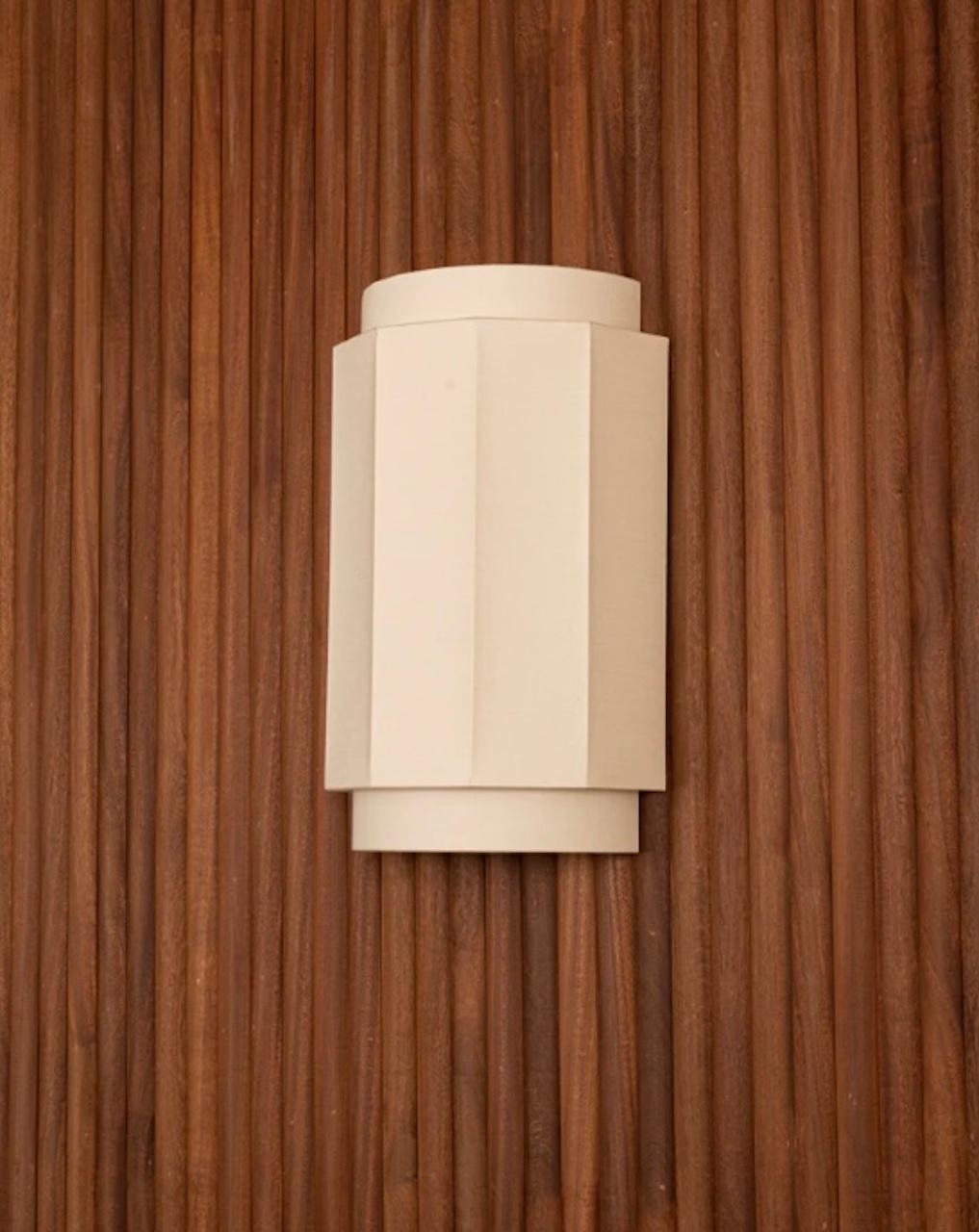 Handmade linen wall sconce with a layered shade. Made in Spain. 