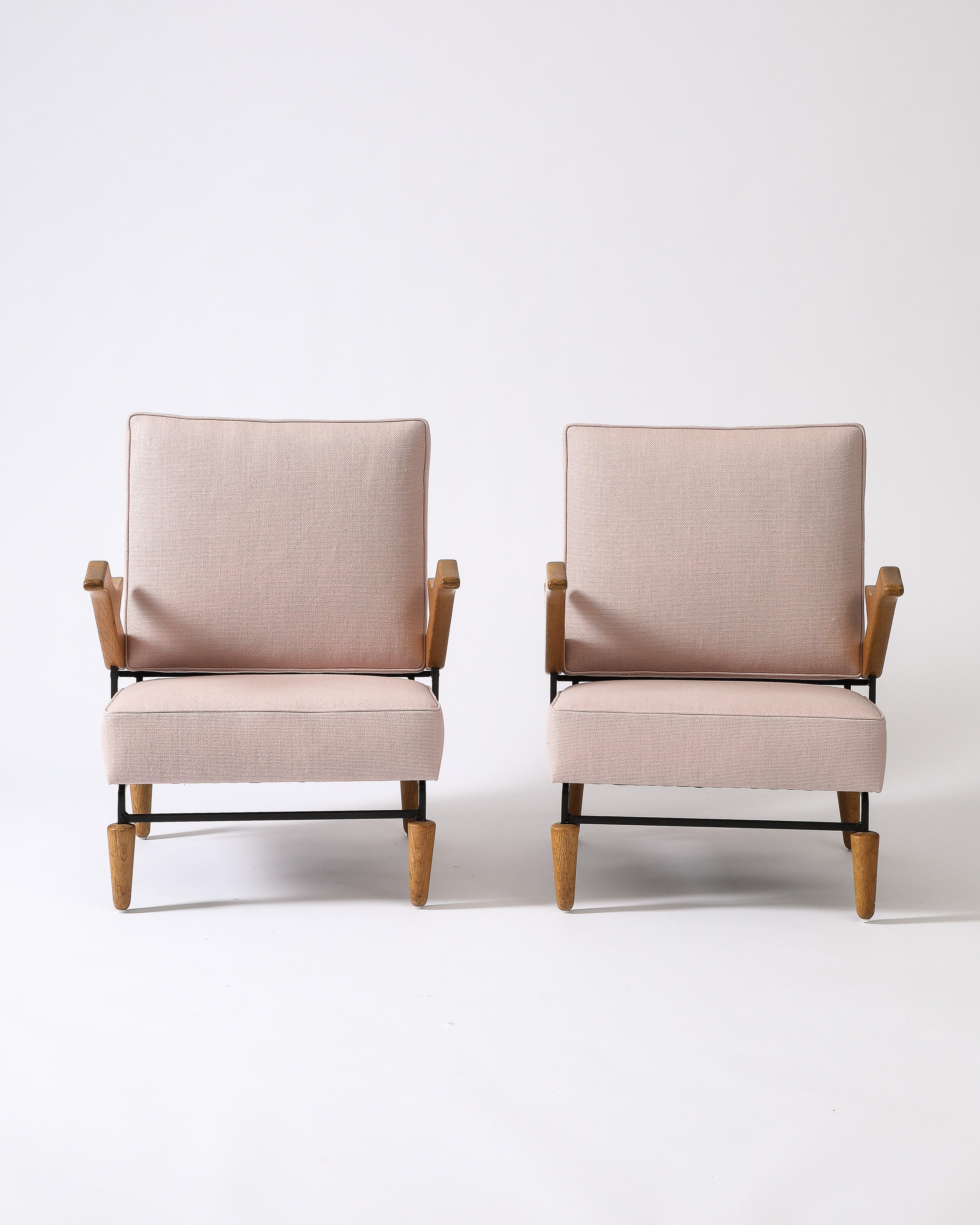 Priced individually; two available.

Anonymous and possibly unique armchair, in the manner of Pierre Guariche. The armrests and feet on these chairs are very striking, constructed of hand-carved oak.