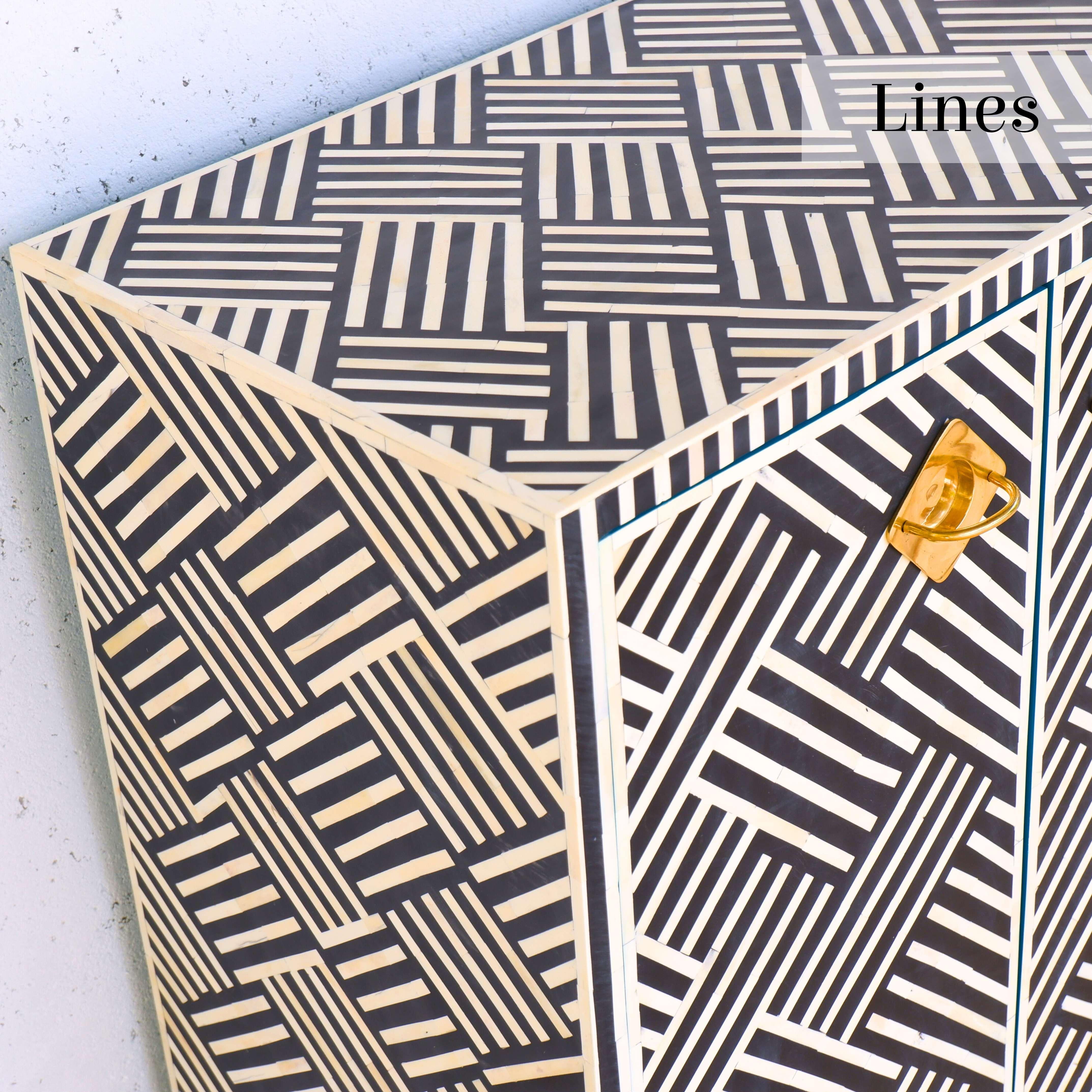 Elevate your home with Artisanal's exquisite black-and-white inlay cabinet—a stunning addition that seamlessly combines timeless craftsmanship with modern sophistication.

Adorned with intricate geometric stripe patterns, this cabinet showcases the