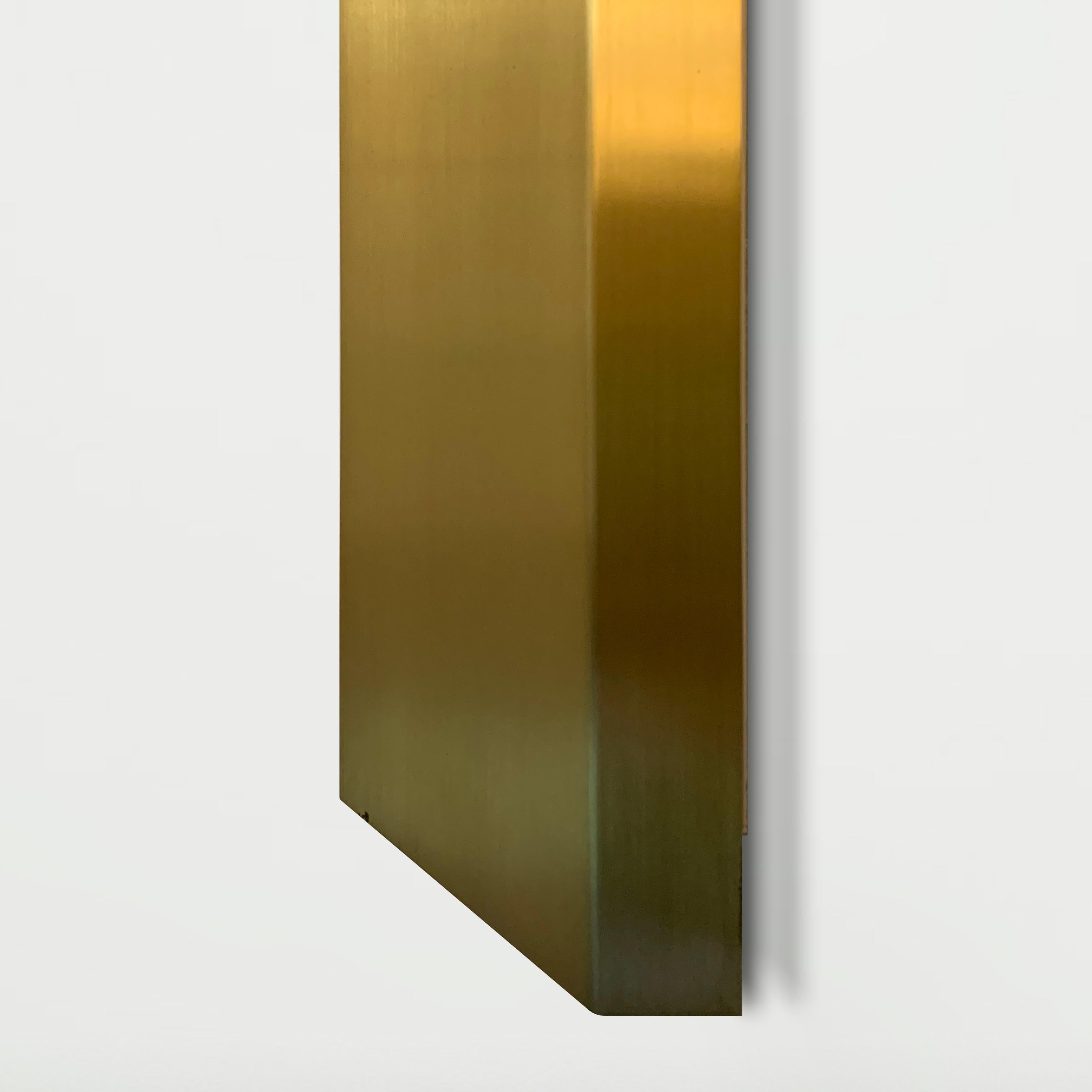 Bi-emission LED wall lamp with extruded aluminum lamp body and brushed brass exterior finish. Customizable with ceramic elements as an exterior finish. Indirect light fixture. Possibility of emergency module. Drivers and accessories for wall
