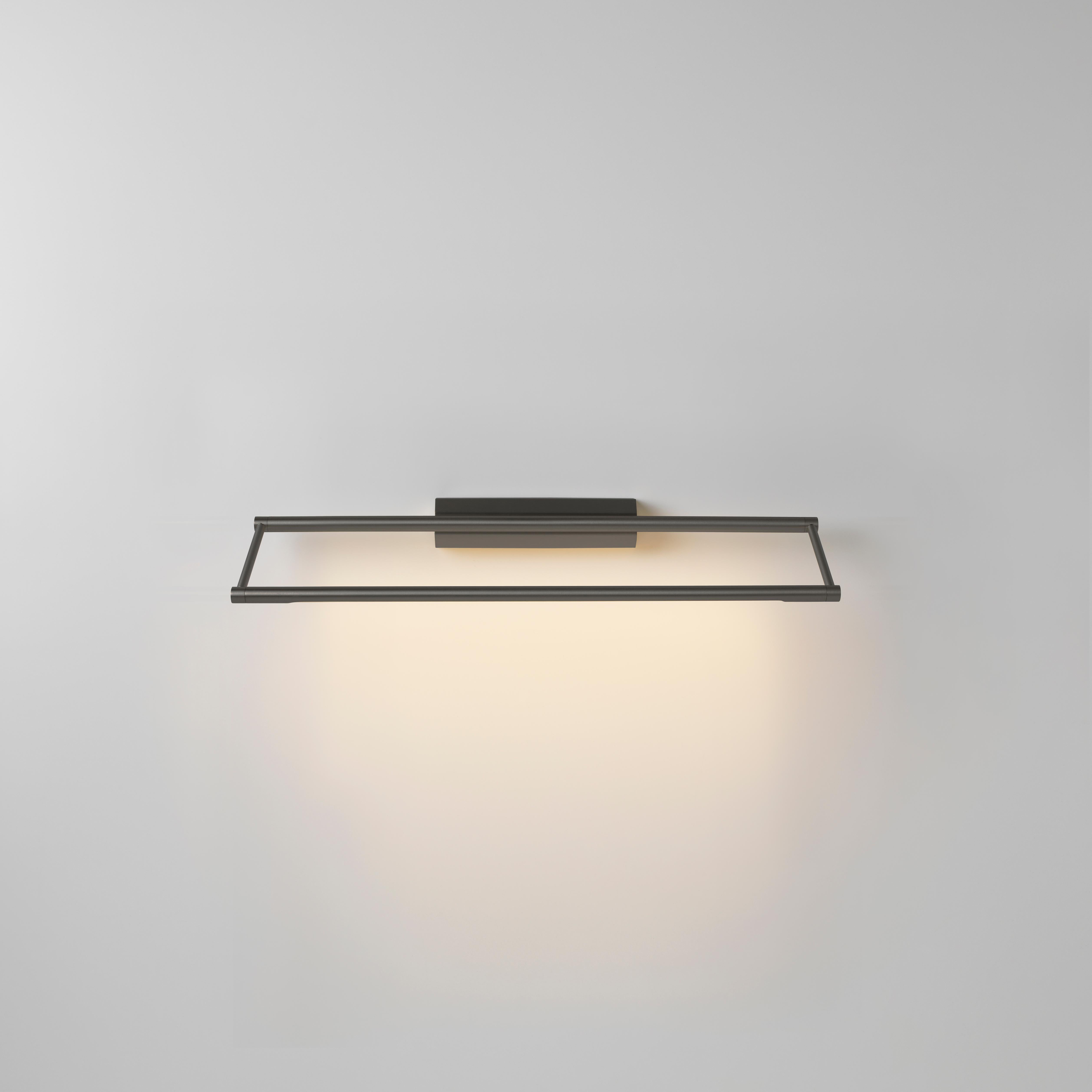 Link 525 graphite wall light by Emilie Cathelineau
Dimensions: D52.5 x W11.5 X H4.4 cm
Materials: Solid brass, satin polycarbonate diffuser, black textile cable (2m)
Others finishes and dimensions are available. 

All our lamps can be wired