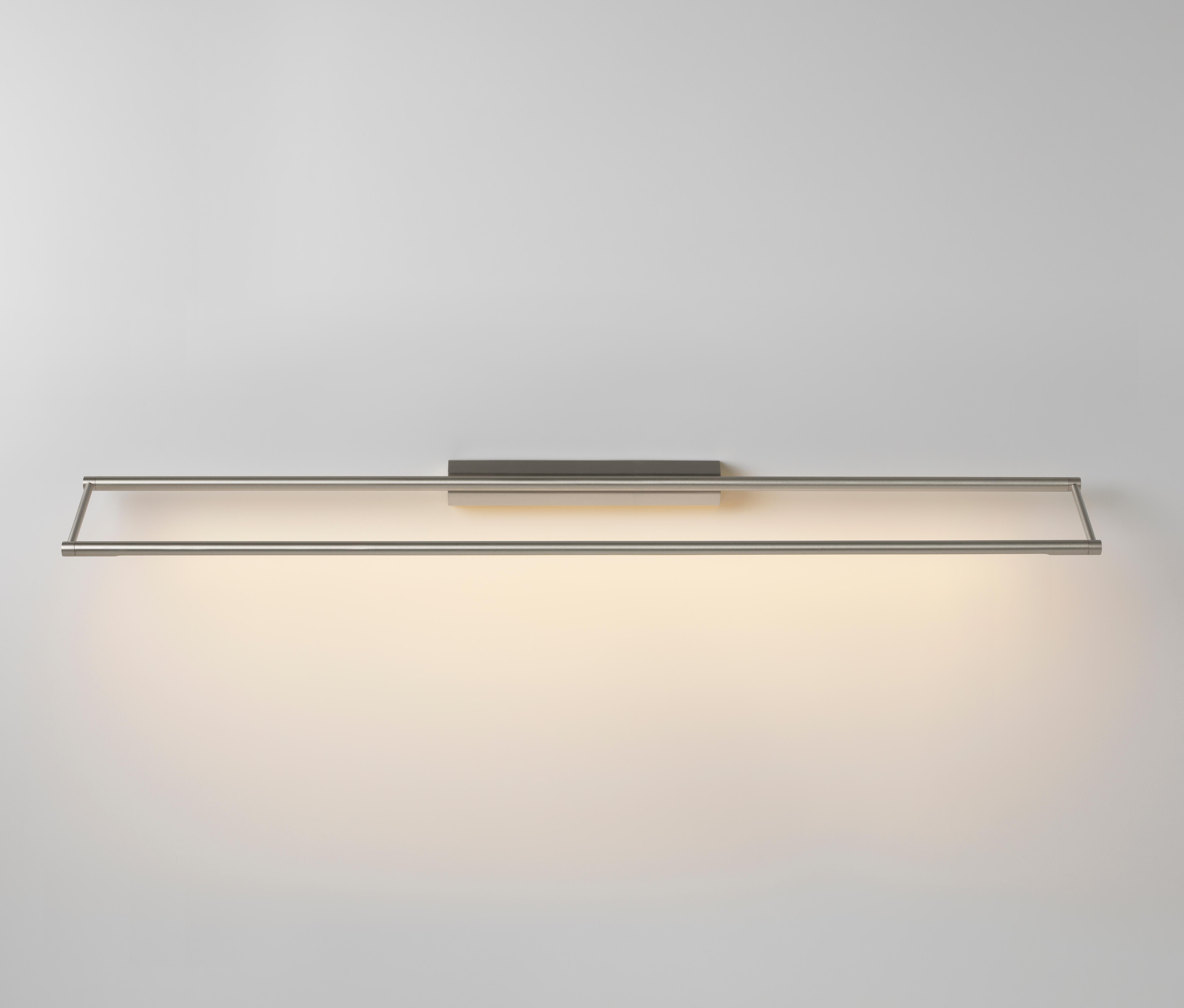 Link 985 Nickel wall light by Emilie Cathelineau
Dimensions: D 98.5 x W 11.5 x H 4.4 cm
Materials: Solid brass, Satin polycarbonate diffuser, black textile cable (2m)
Others finishes and dimensions are available.

All our lamps can be wired