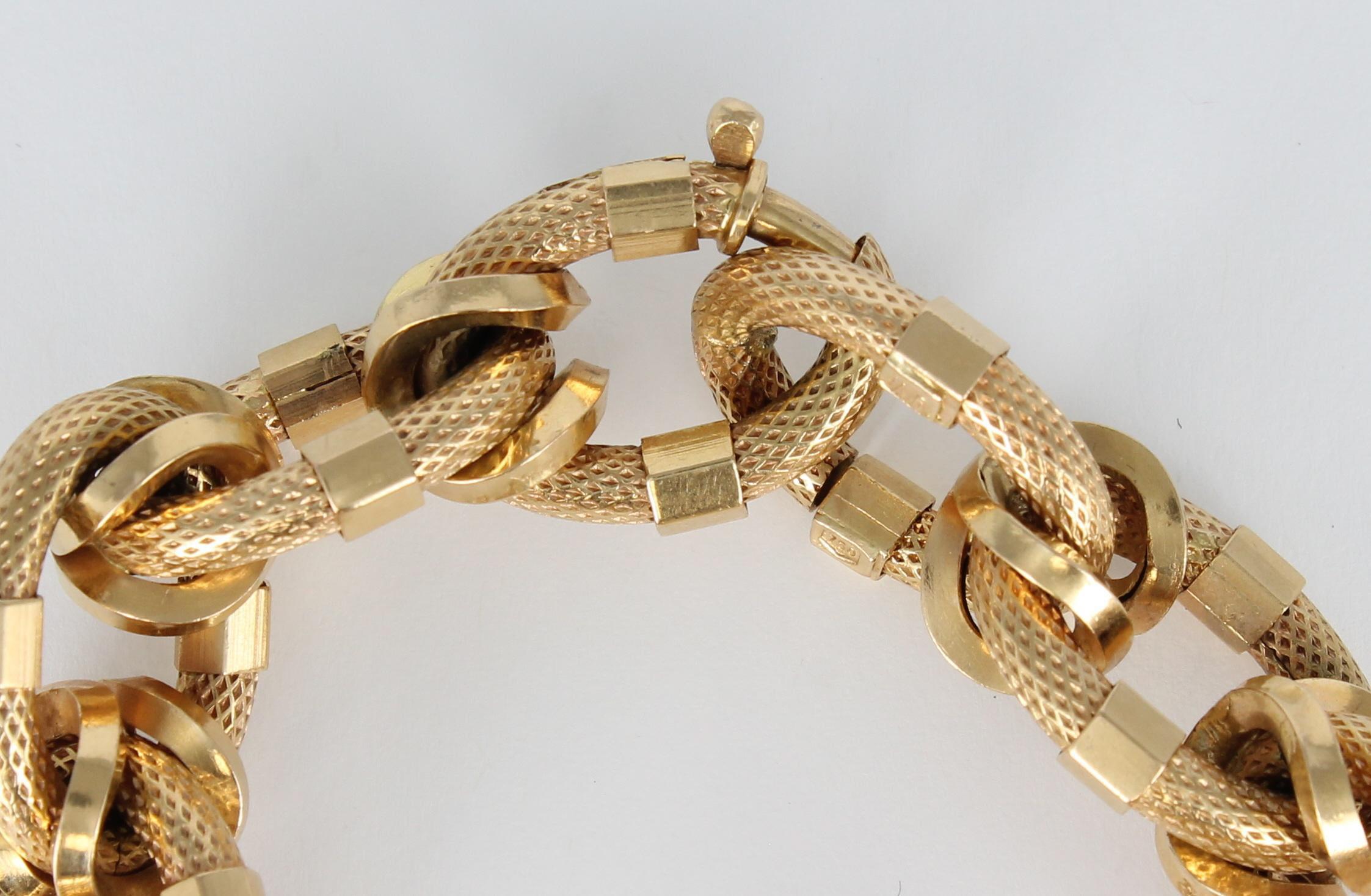 Beautifully rendered textured links connect to create this stunning 9 inch 18 karat yellow gold bracelet.  The links are 1 inch long and 5/8 inch wide and are connected by polished gold links.  Wrap your wrist in a masterful maze of links when
