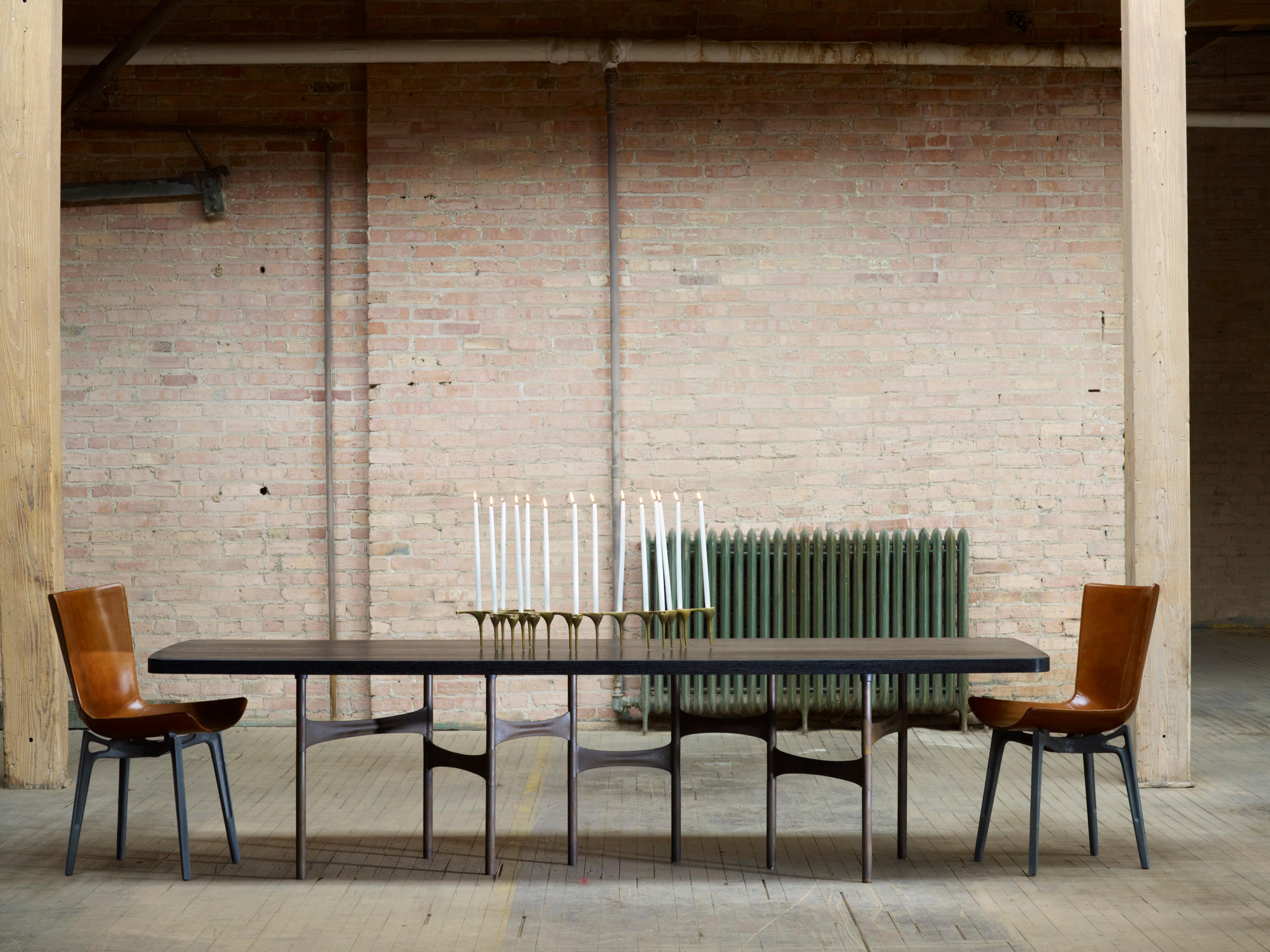 The link dining table is a modular system comprising patinaed cast aluminum and steel components and can be adapted for use with any size table. Table tops are made to order at our studio in Chicago and are available in an extensive range of species