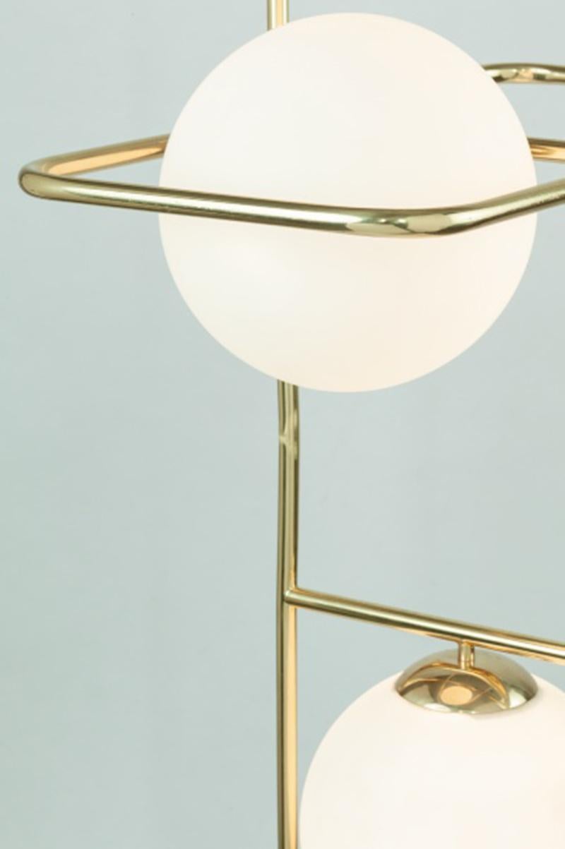 With a shimmering round and clear design, the link suspension lamp brings a unique and alluring style any space. A poetic, organic shape that expresses a feeling of light weight and motion, made of polished brass and translucent glass globes.