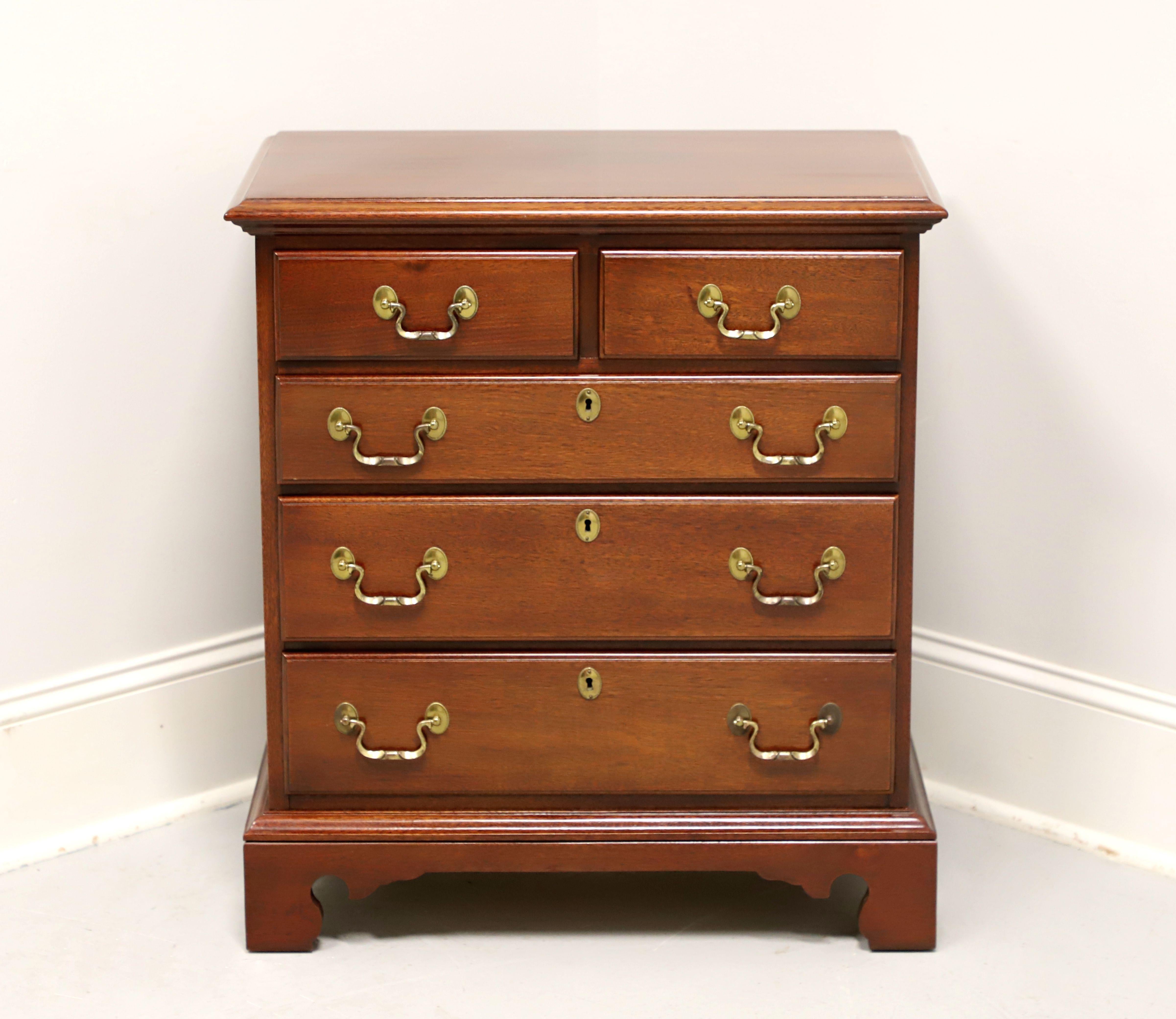 A Chippendale style bedside chest by Link-Taylor, from their Heirloom Gallery, the Planters. Solid mahogany with brass hardware, bevel edge to the top, side handles, and bracket feet. Two over three drawers of dovetail construction, with three lower