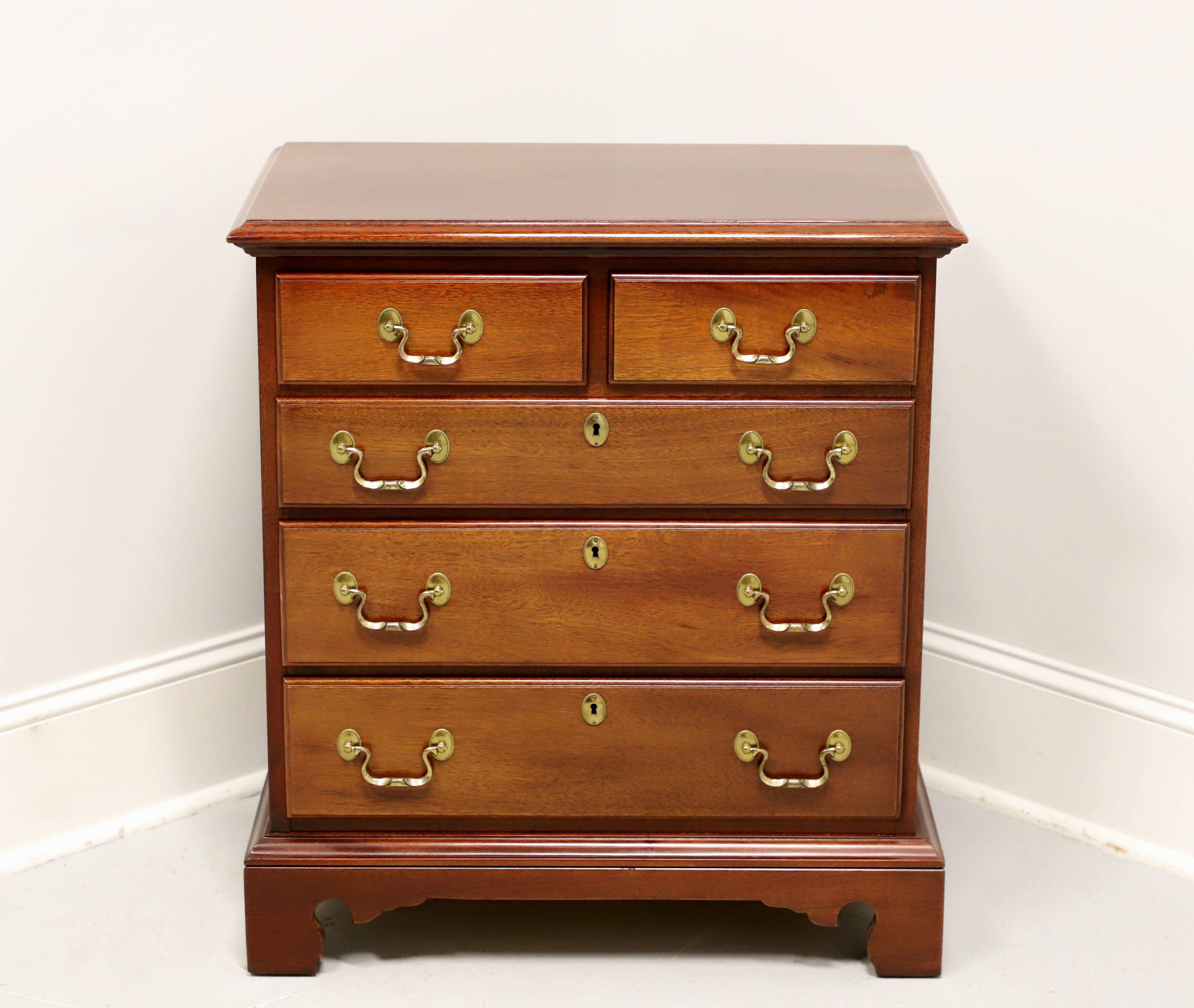 A Chippendale style bedside chest by Link-Taylor, from their Heirloom Gallery, the Planters. Solid mahogany with brass hardware, ogee edge to the top, side handles, and bracket feet. Two over three drawers of dovetail construction, with three lower