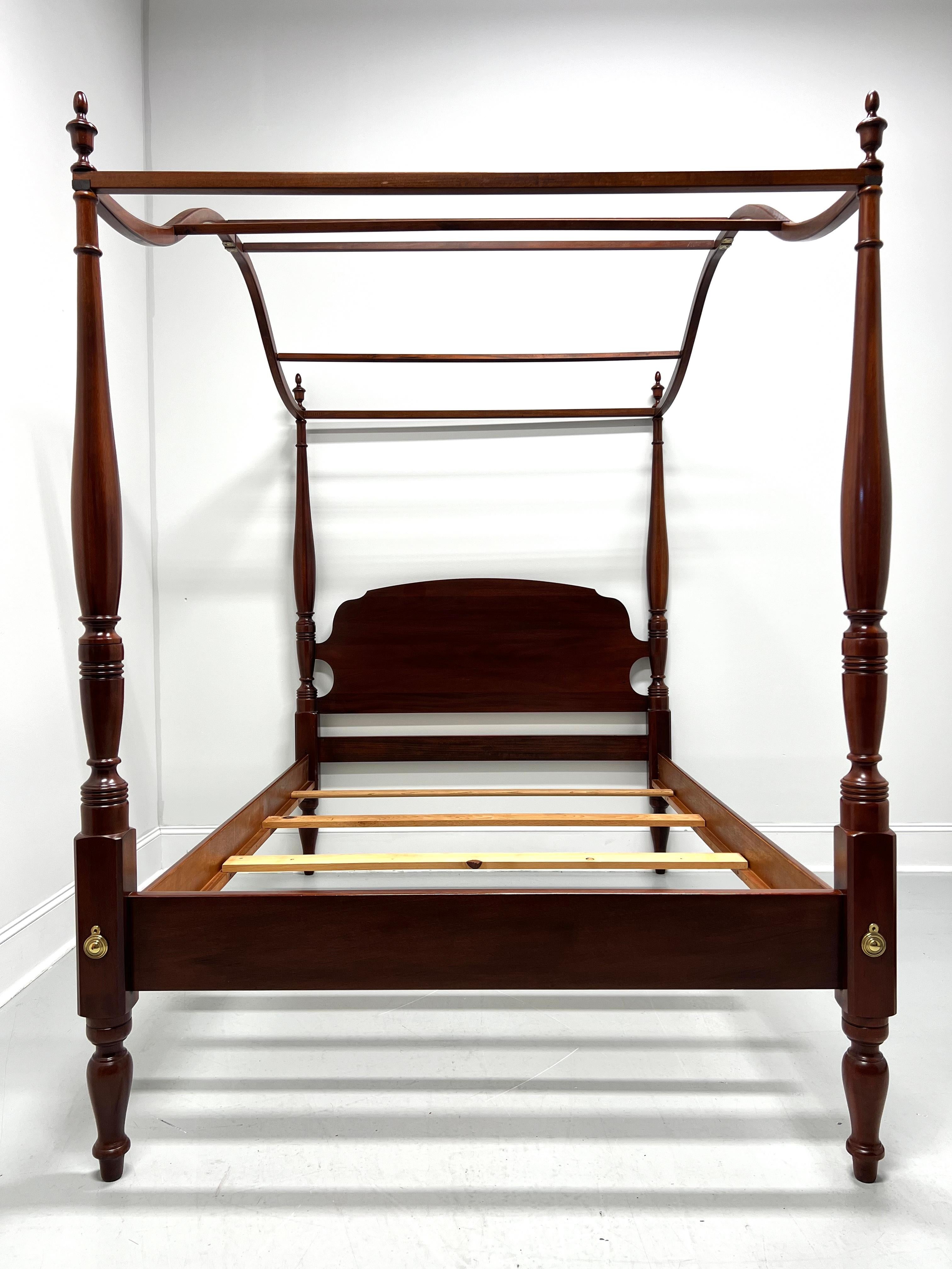A Chippendale style full size poster bed with canopy by Link-Taylor, from their Heirloom Gallery. Solid mahogany with carved arch headboard, four turned posts capped by finials, an open arched wood slat canopy, brass hardware, metal clip held side