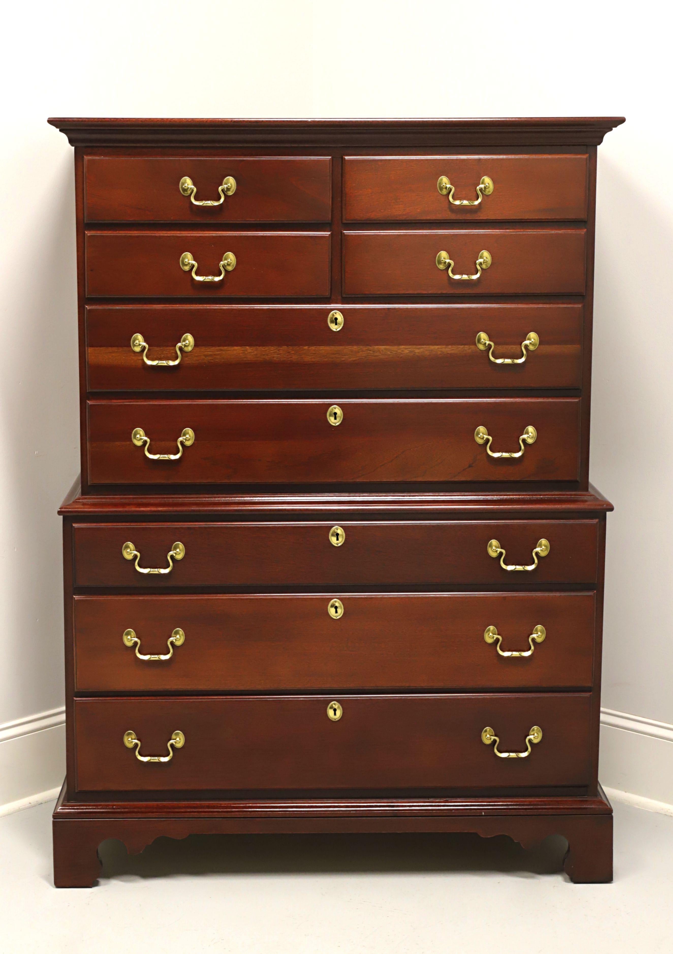 A Chippendale style chest on chest by Link-Taylor. Solid heirloom mahogany with brass hardware and bracket feet. Upper section has four smaller over two larger drawers. Lower section has three larger drawers. All drawers are of dovetail construction
