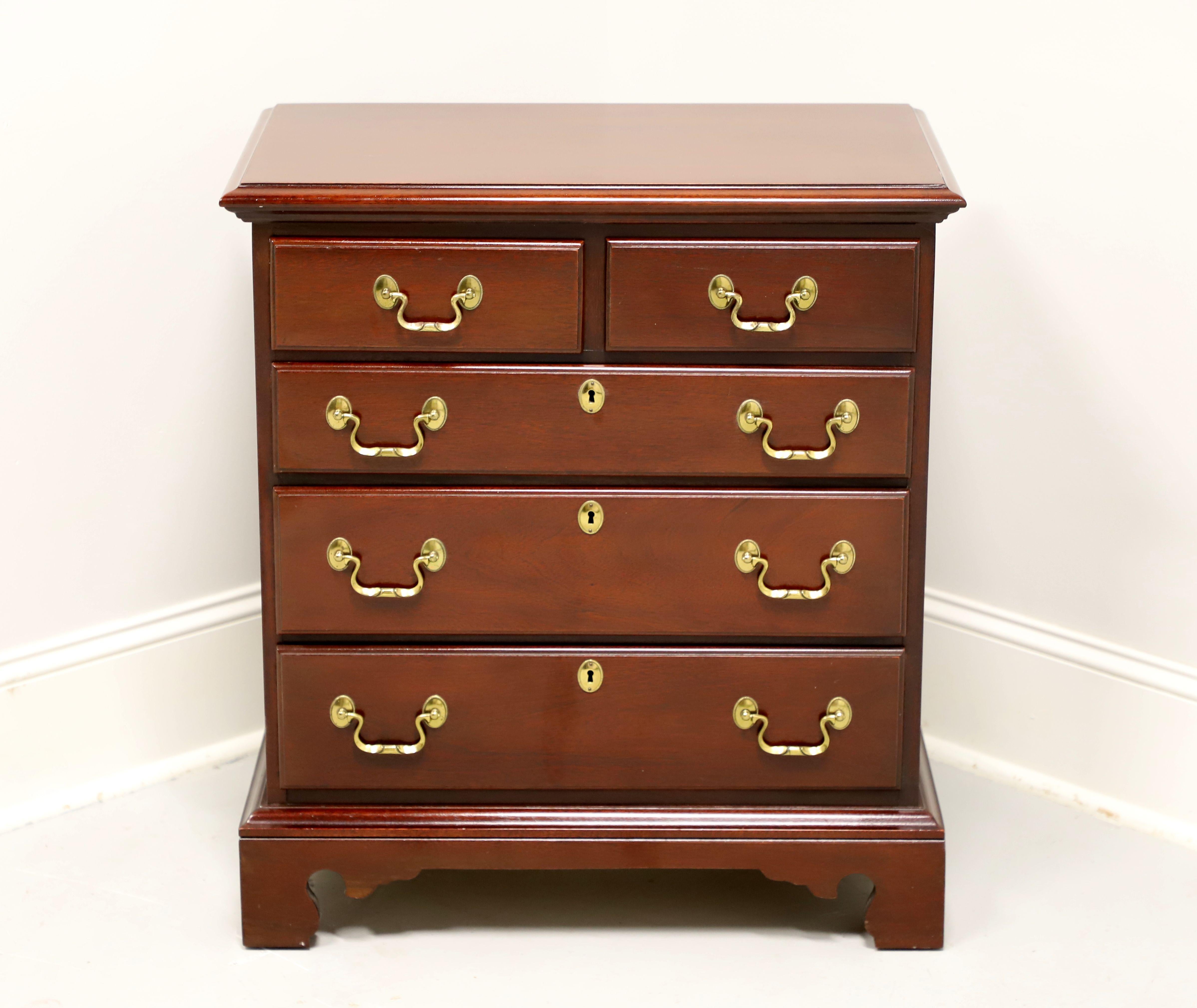 A Chippendale style bedside chest by Link-Taylor, from their Heirloom Gallery, the Planters. Solid mahogany with brass hardware, ogee edge to the top, side handles, and bracket feet. Two over three drawers of dovetail construction, with three lower