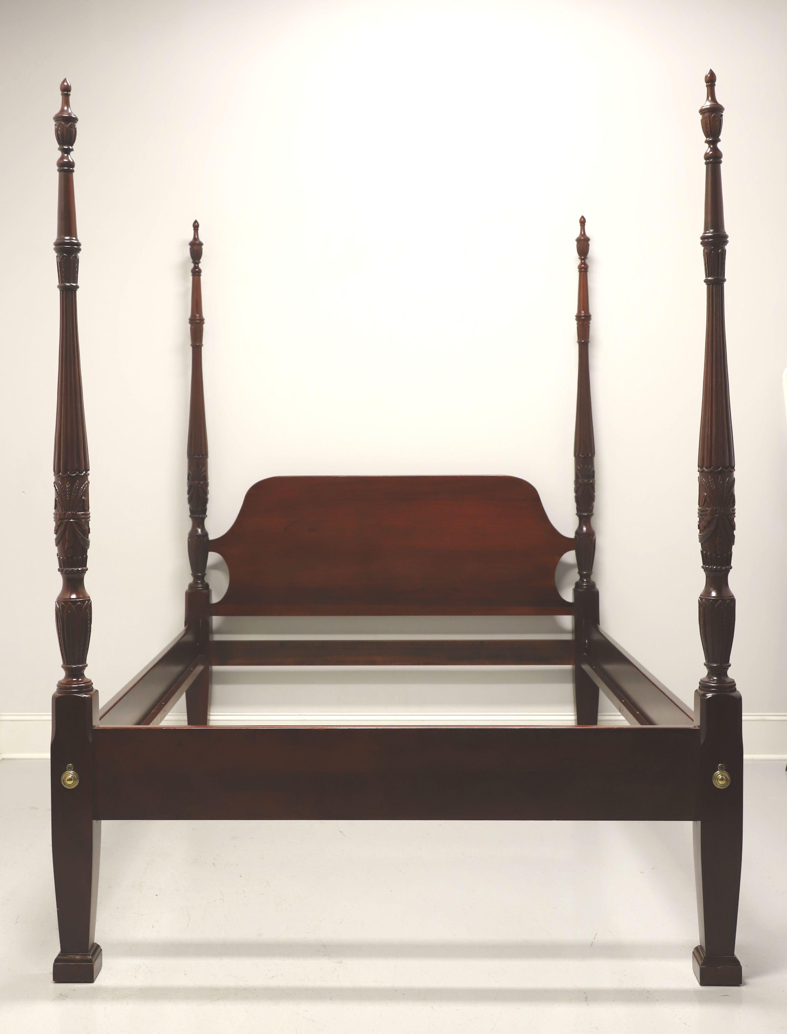 A Chippendale style queen size poster bed by Link-Taylor. Solid heirloom mahogany with arched headboard, four rice carved posts with finials, brass hardware to footboard, bolt held side rails with wood bracers and three wood slats for mattress