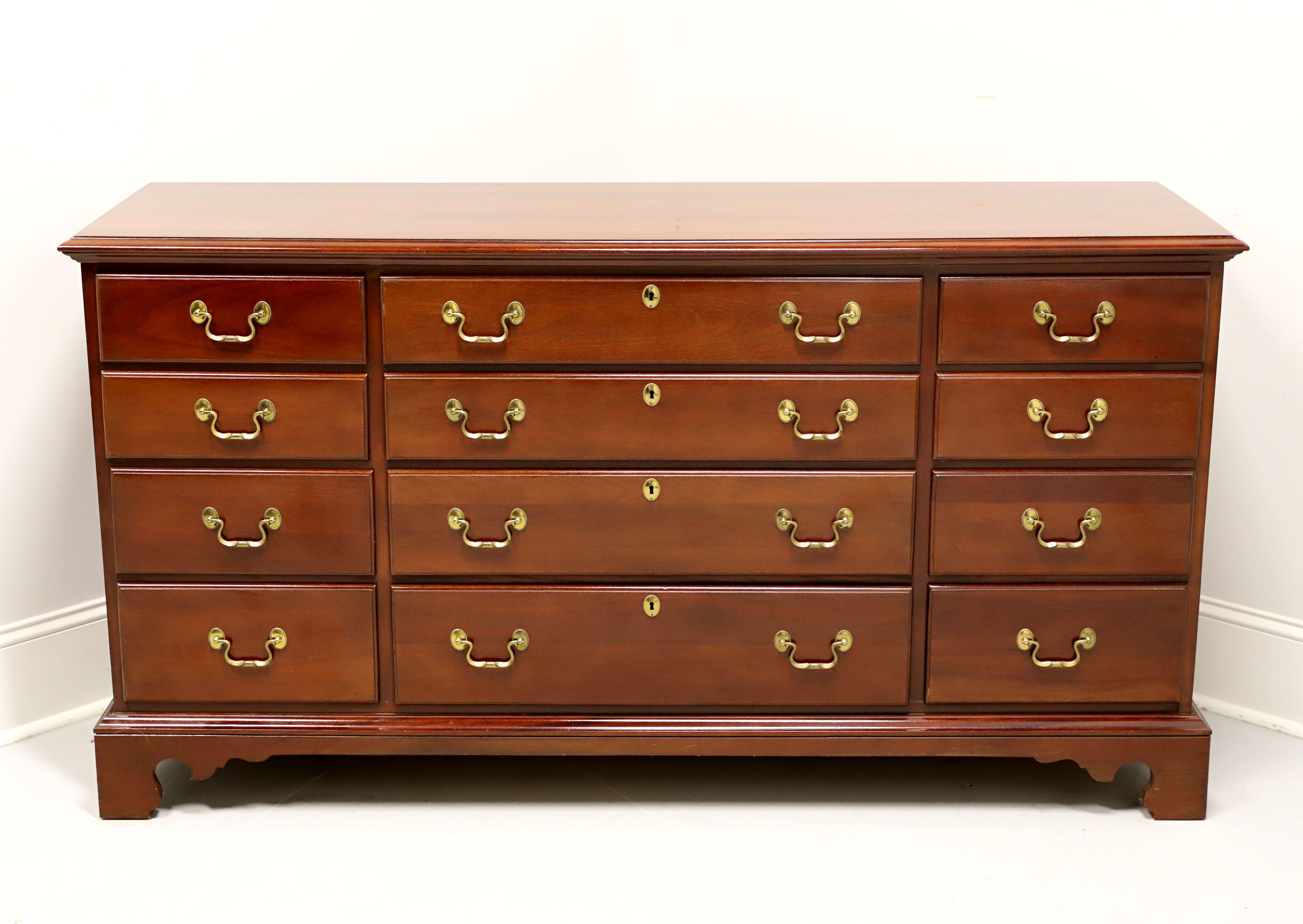 A Chippendale style triple dresser by Link-Taylor, from their Heirloom Gallery, the Beaufort. Solid mahogany with brass hardware, bevel edge to the top, and bracket feet. Features twelve drawers of dovetail construction, four center with faux