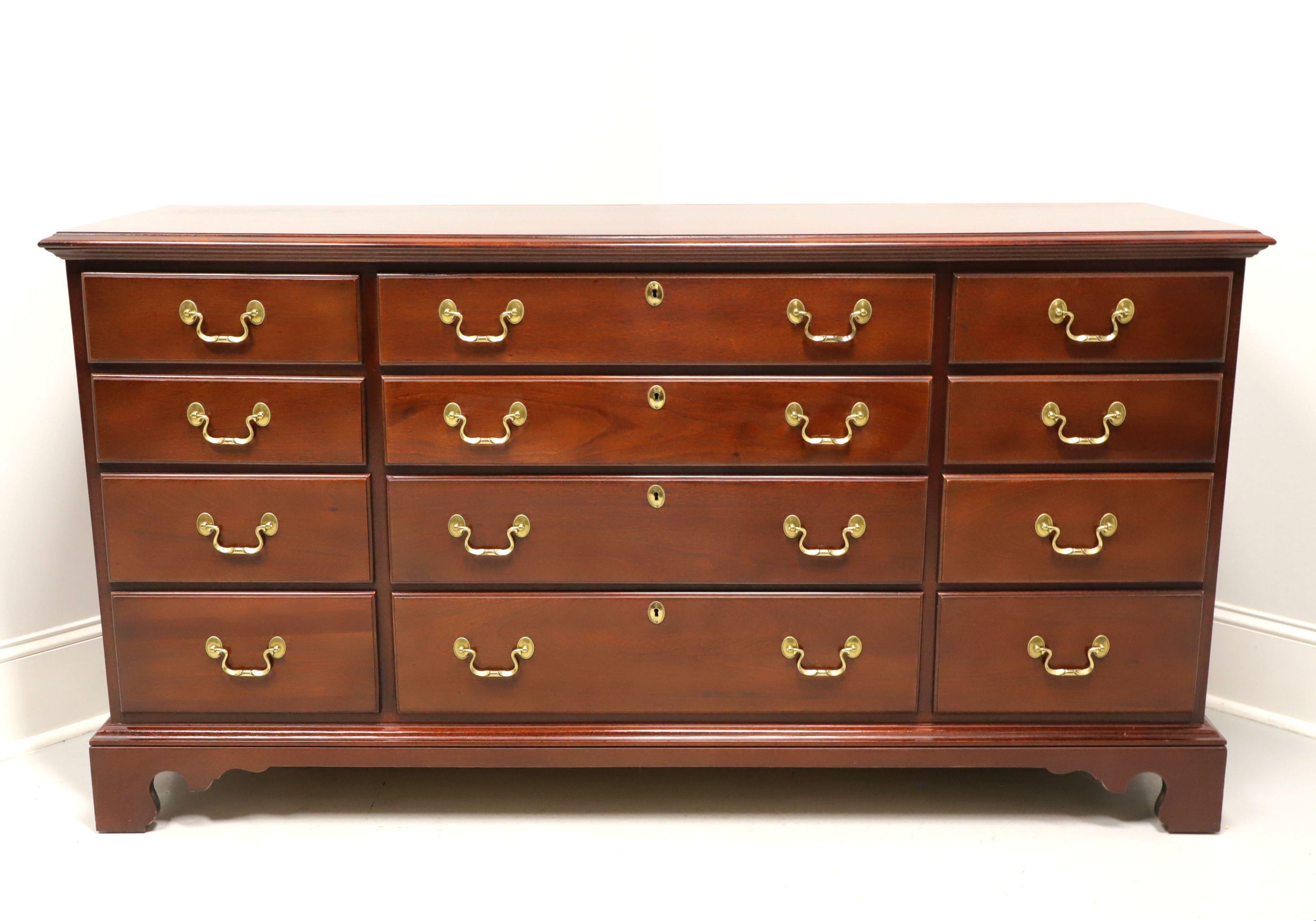 A Chippendale style triple dresser by Link-Taylor, from their Heirloom Gallery, the Beaufort. Solid mahogany with brass hardware, ogee edge to the top, and bracket feet. Features twelve drawers of dovetail construction, four center with faux keyhole