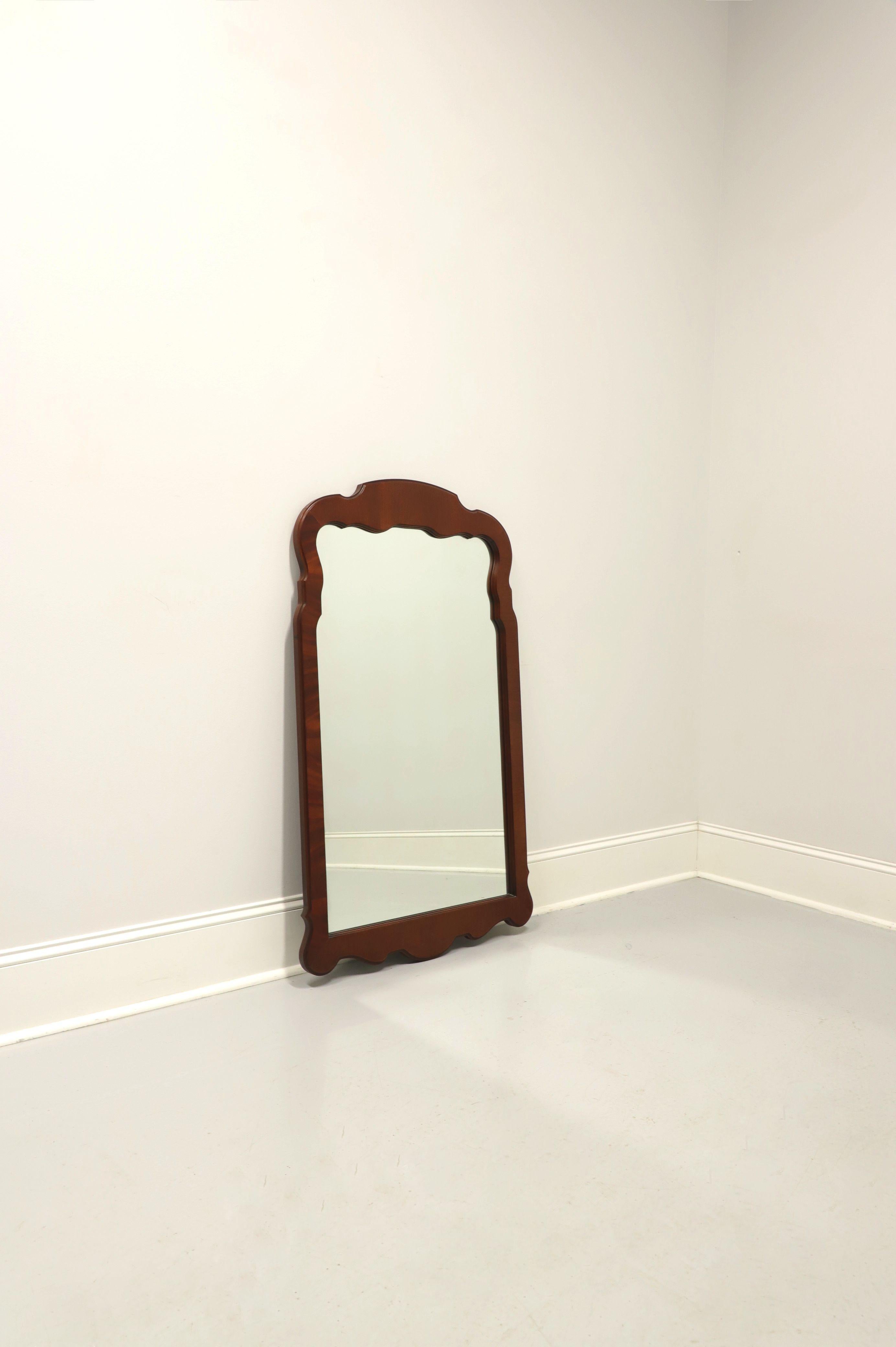 A Chippendale style wall mirror made by Link-Taylor, from their Heirloom Gallery. Mirror glass in a solid mahogany frame with decoratively carved top and bottom. Made in Lexington, North Carolina, USA, circa 1986.

Style #: 910-202

Measures: 28.75