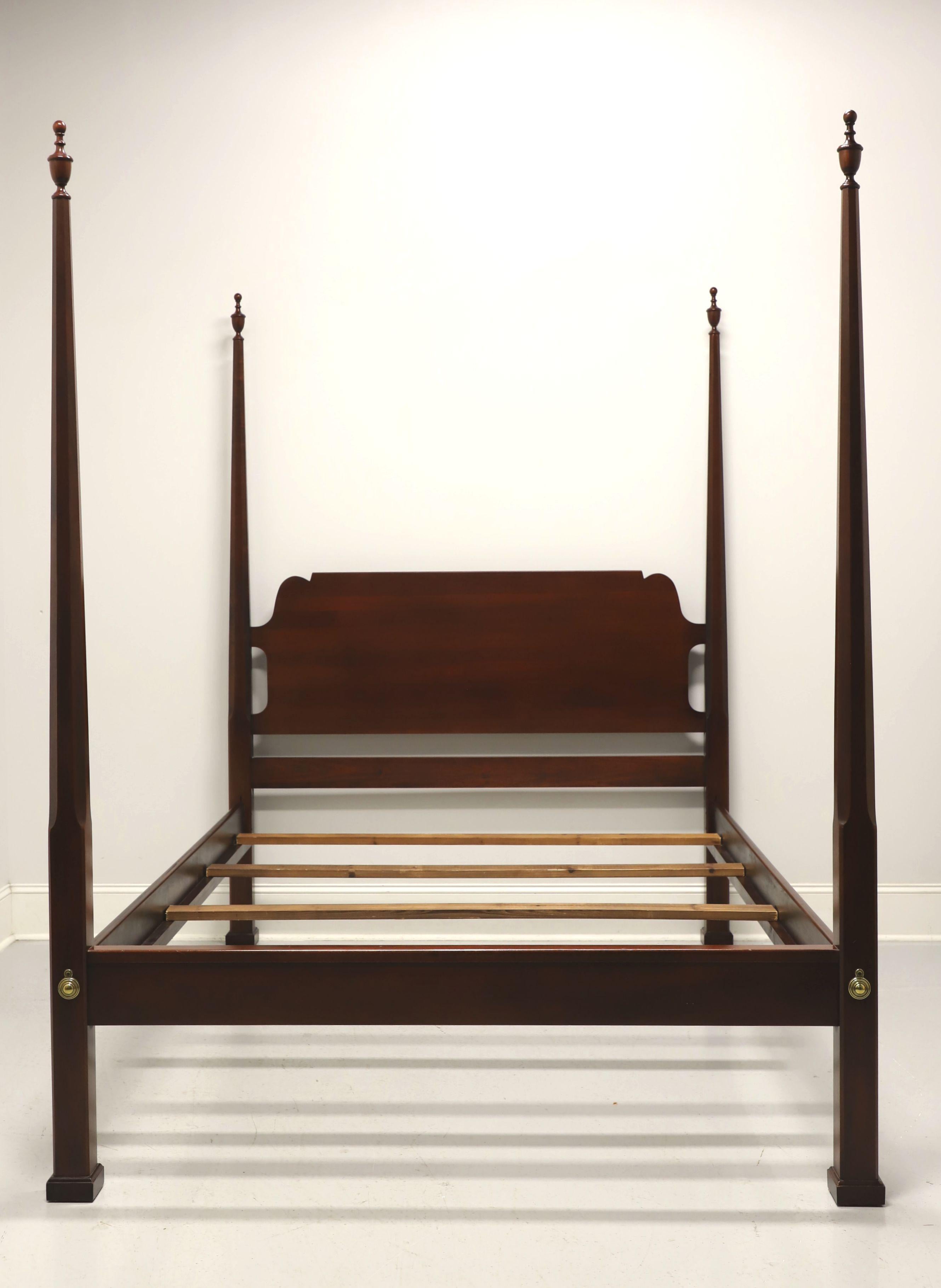 A Traditional style queen size pencil post bed by Link-Taylor. Solid heirloom mahogany with four pencil shaped posts with finials, brass covers to footboard, clip held side rails with wood bracers and four wood slats for mattress support. Made in