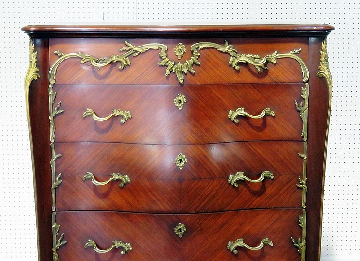 This is a superbly crafted Francois Linke style 5-drawer high chest with bronze mounts. The dresser is in mahogany with some of the finest bronze mounts and could easily be mistaken as Linke by a passerby. The piece dates to the late 1800s and is an
