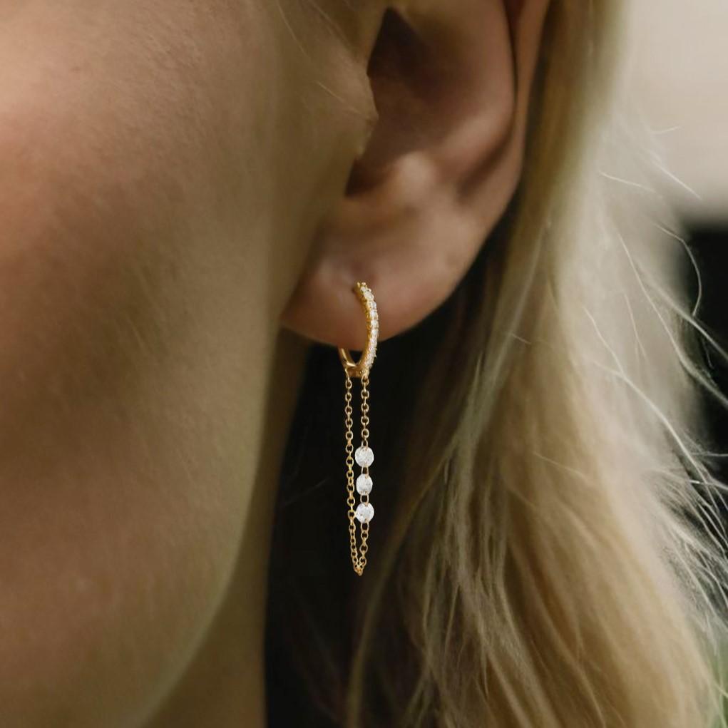 Crafted in 14K yellow and white gold, the Linked Chain 14K Yellow Gold Diamond Huggie Earrings feature natural diamonds (D 0.55CT). These stunning earrings weigh 1.70 grams and showcase an elegant infinity drop design, blending timeless beauty with