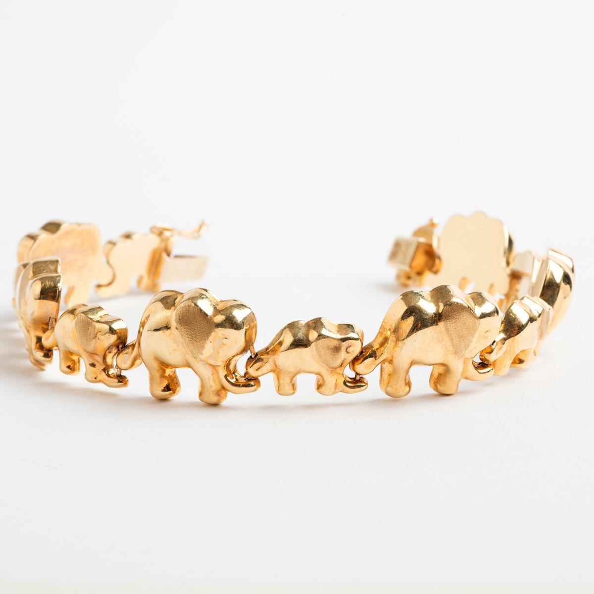 Our 14k yellow gold imported bracelet features mother and child elephants linked around the chain. Secured by a box and tongue clasp with figure of 8 safety. Weight: 17.9g, length: 18cm, We date production to circa 1980s.

A unique piece within our