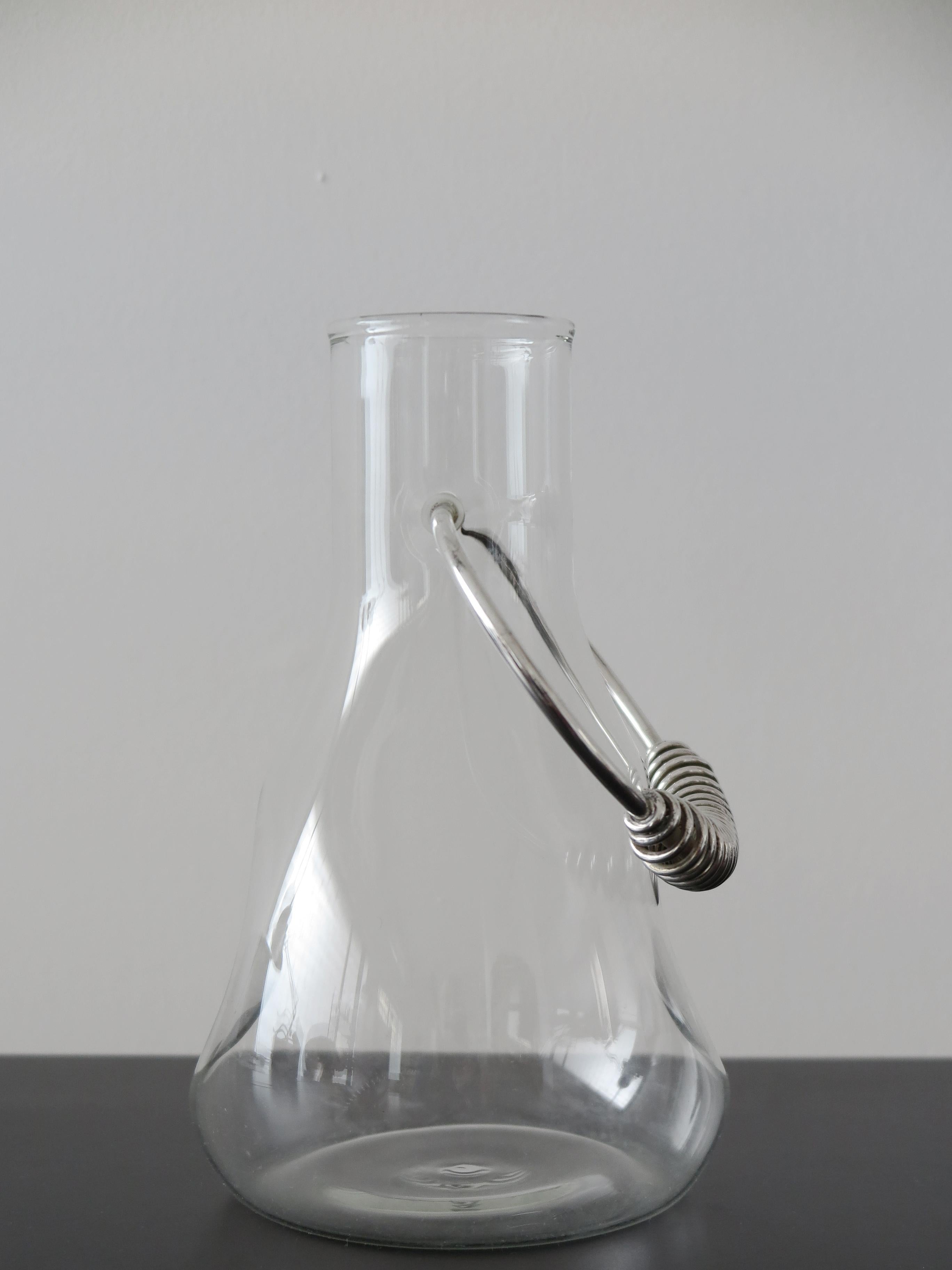 Italian glass carafe jug with silvered metal handle designed by Lino Sabattini and manufactured by Argenterie Sabattini, Italy 1970s

Please note that the item is original of the period and this shows normal signs of age and use.